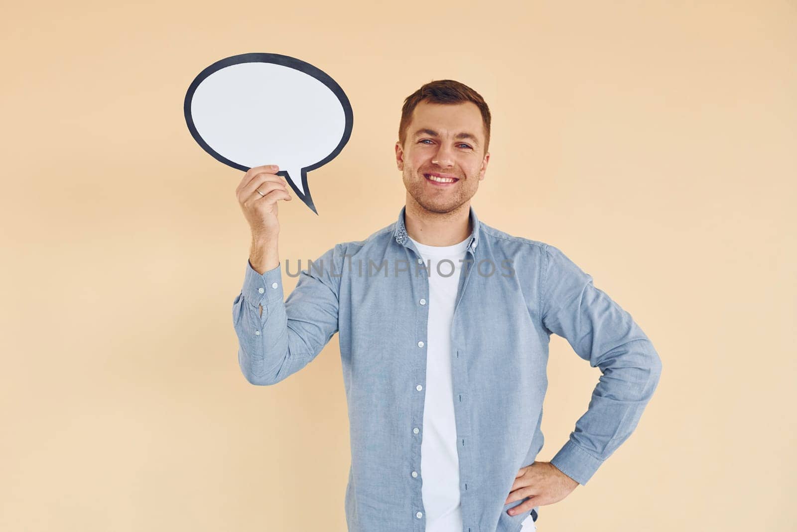 Positive emotions. Man standing in the studio with empty signs for the text.