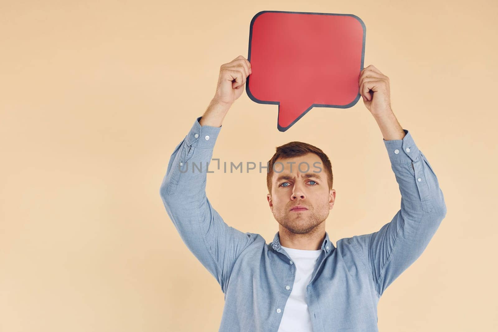 Facial expression. Man standing in the studio with empty signs for the text.