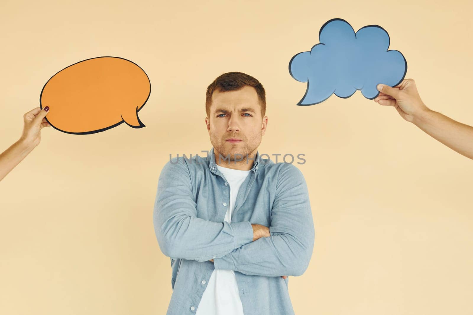 Thinking about two ideas. Man standing in the studio with empty signs for the text.