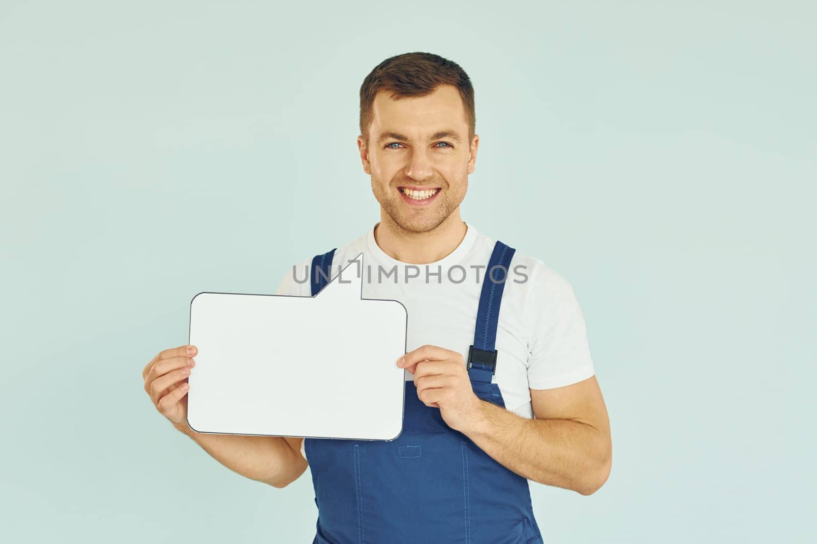 Worker saying something. Man standing in the studio with empty signs for the text.