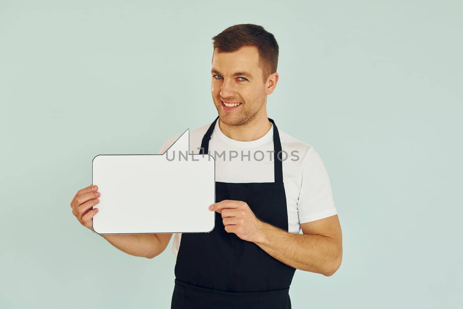 Sincere emotions. Man standing in the studio with empty signs for the text.