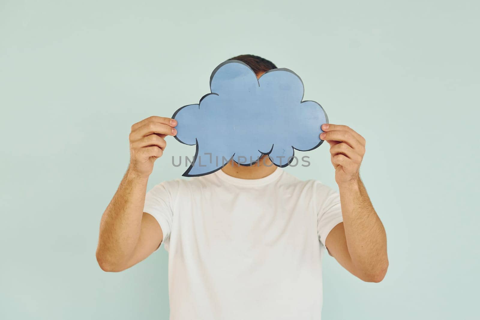 Cloud looking signs. Man standing in the studio.