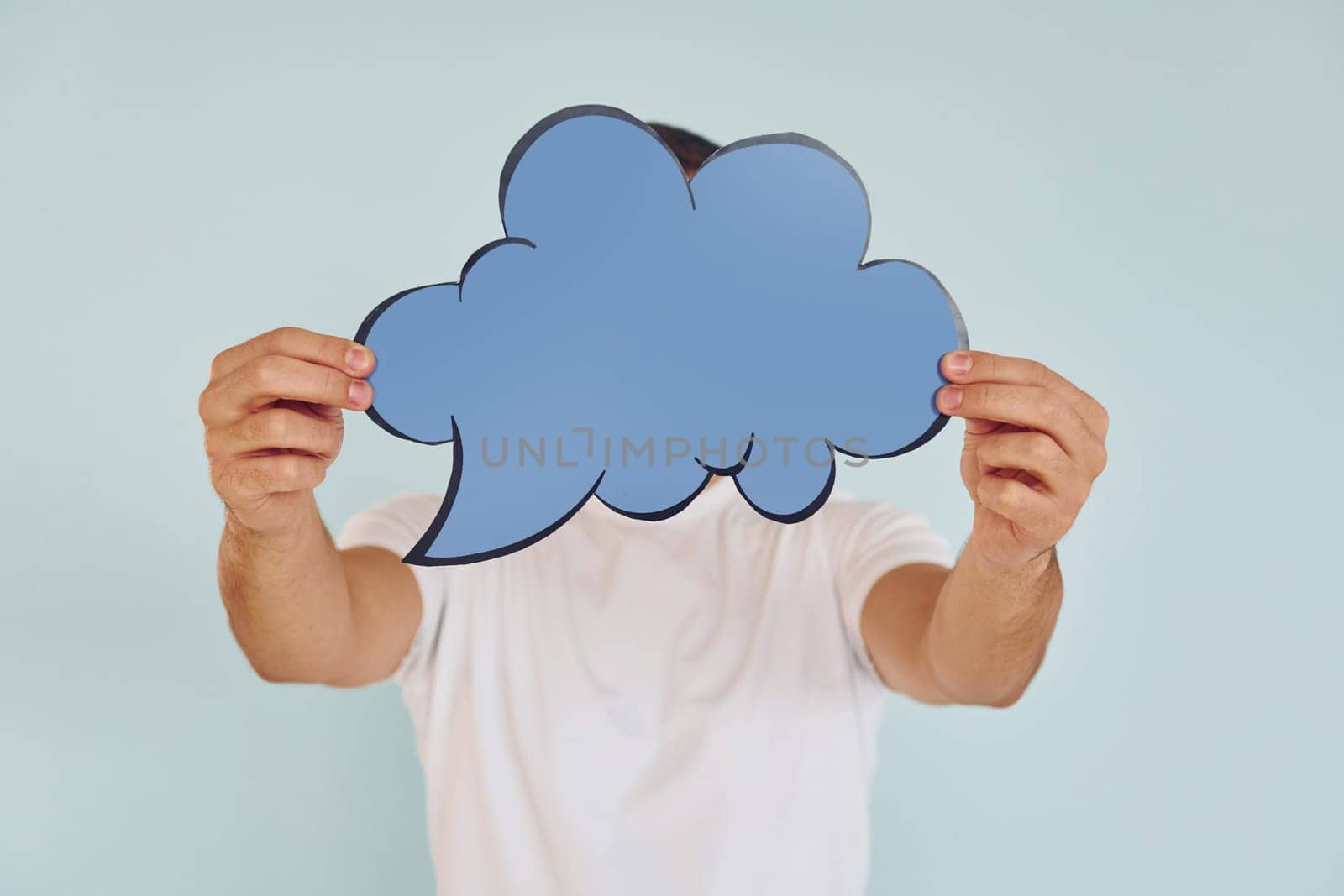Cloud looking signs. Man standing in the studio.
