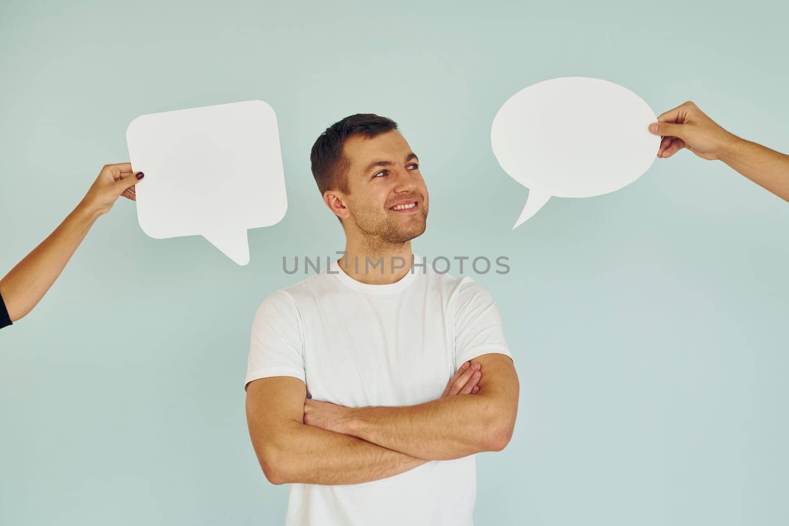 In white shirt. Man standing in the studio with empty signs for the text.