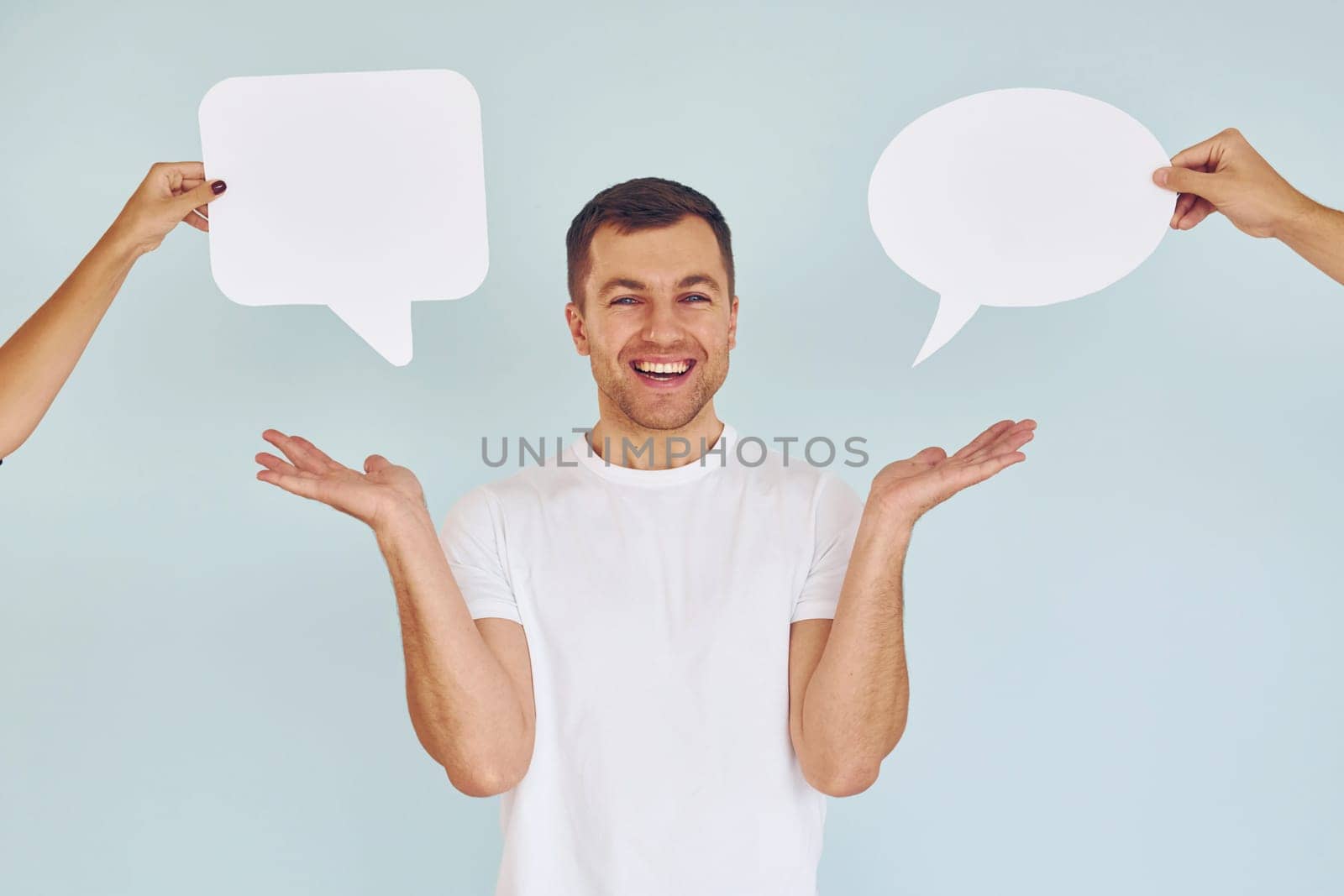 In white shirt. Man standing in the studio with empty signs for the text.