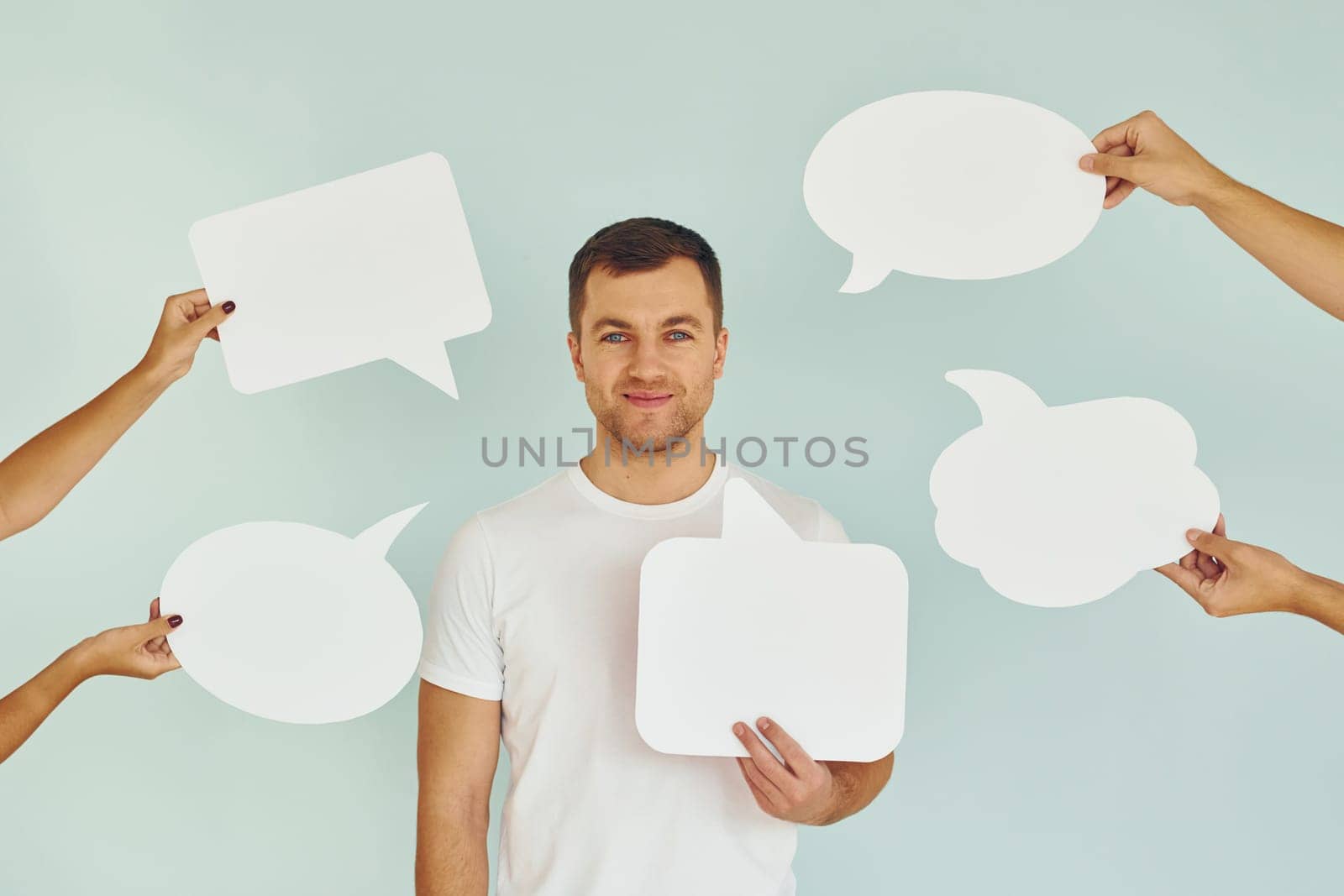 Many of the different thoughts. Man standing in the studio with empty signs for the text.