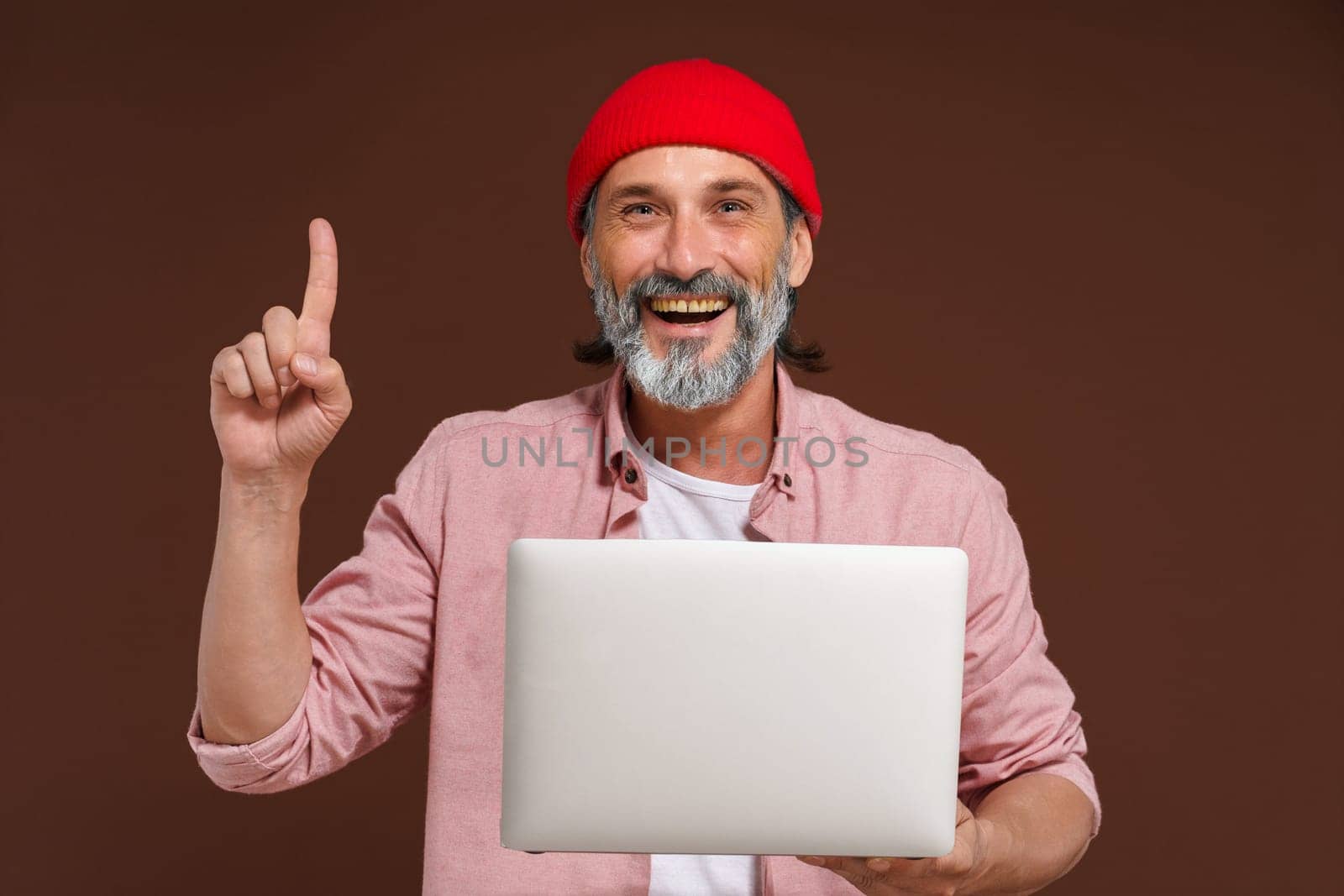 Available information on the concept network. Eureka. Quick search for solution. man holds laptop and pointing up with finger of other hand, symbolizing eureka moment of finding quick solution through online networks and digital technology. High quality photo