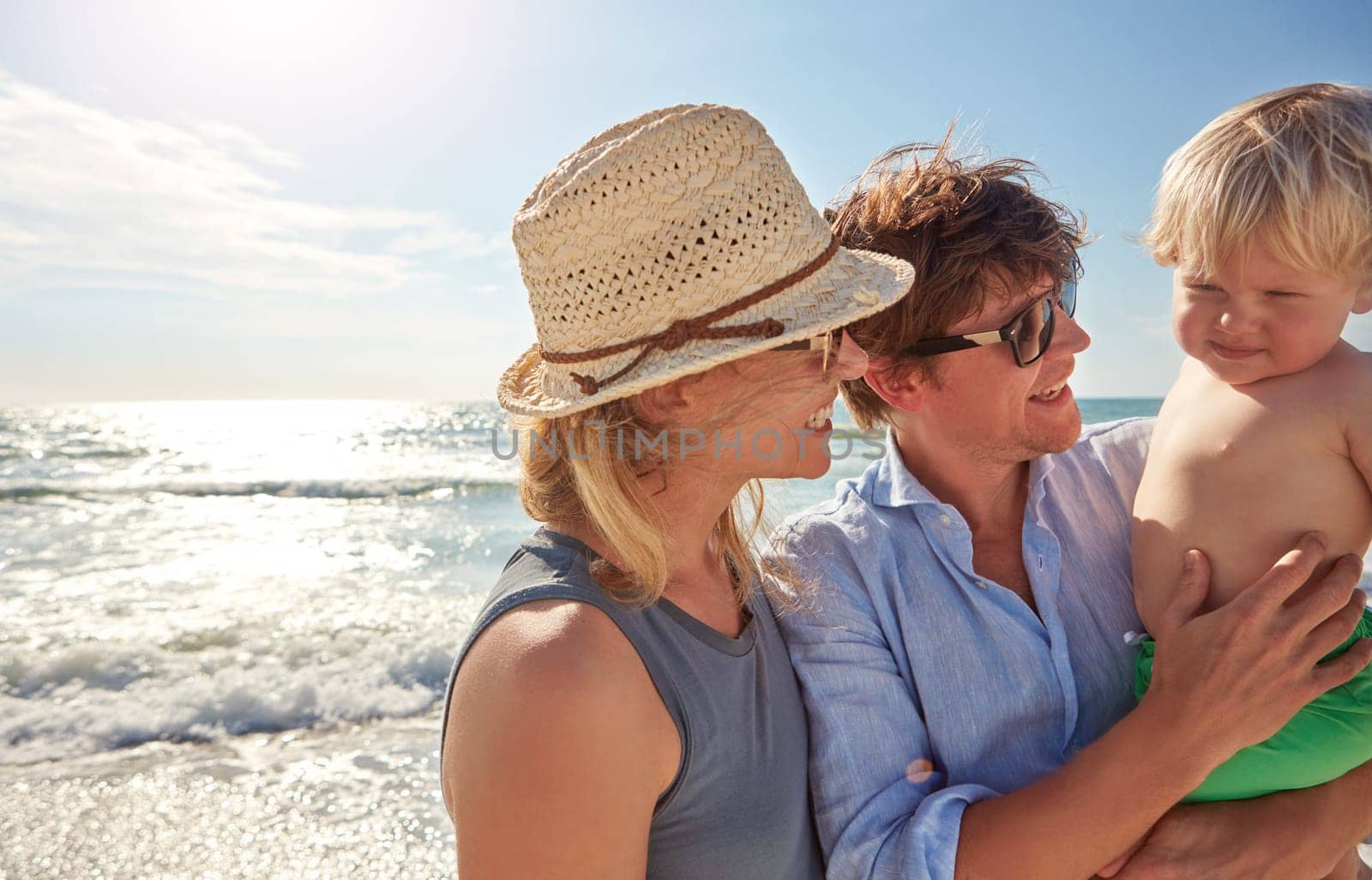 Introducing him to the beach. a young family enjoying a summer day out at the beach