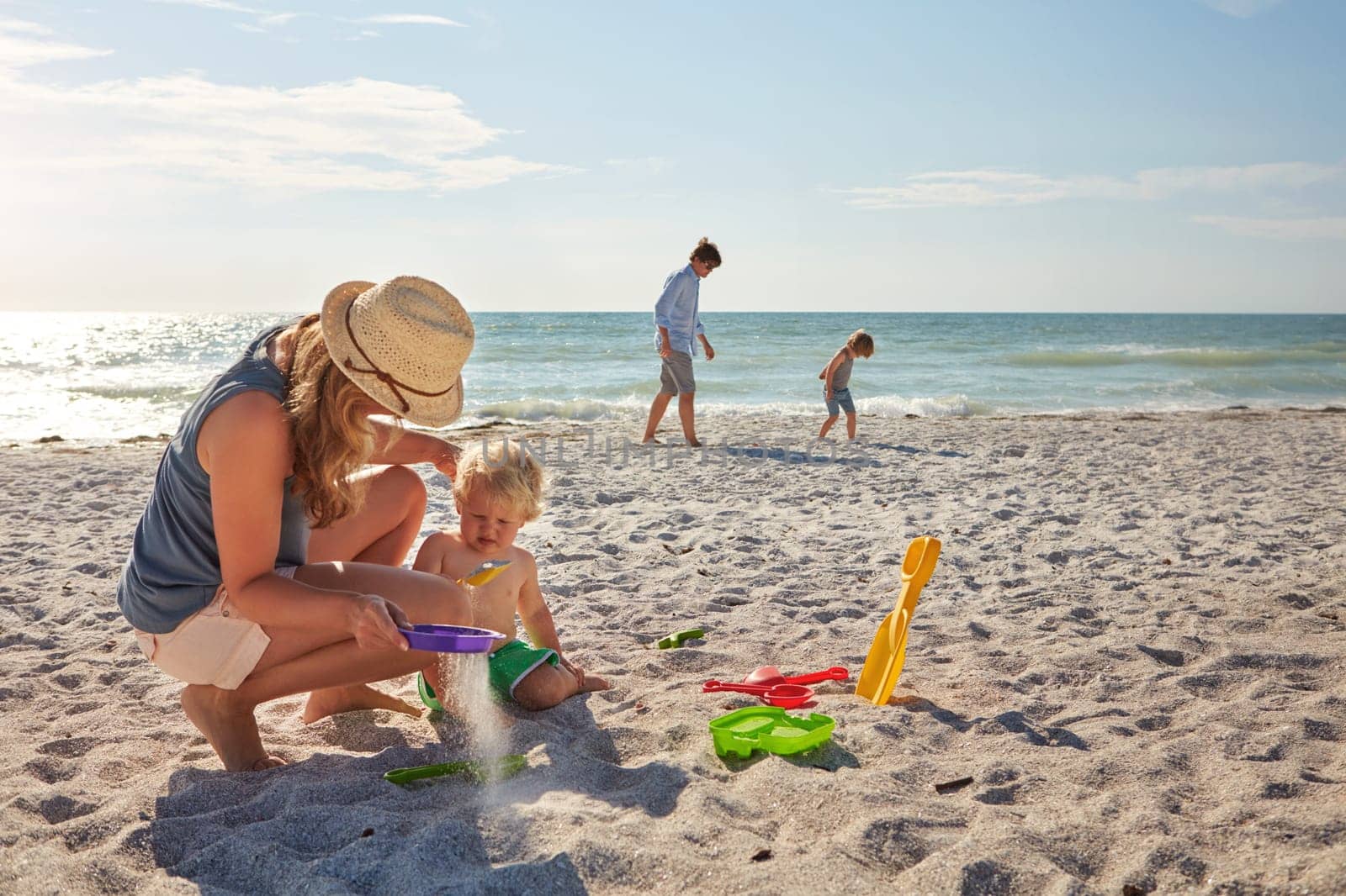 Playing in the sand. a young family enjoying a summer day out at the beach