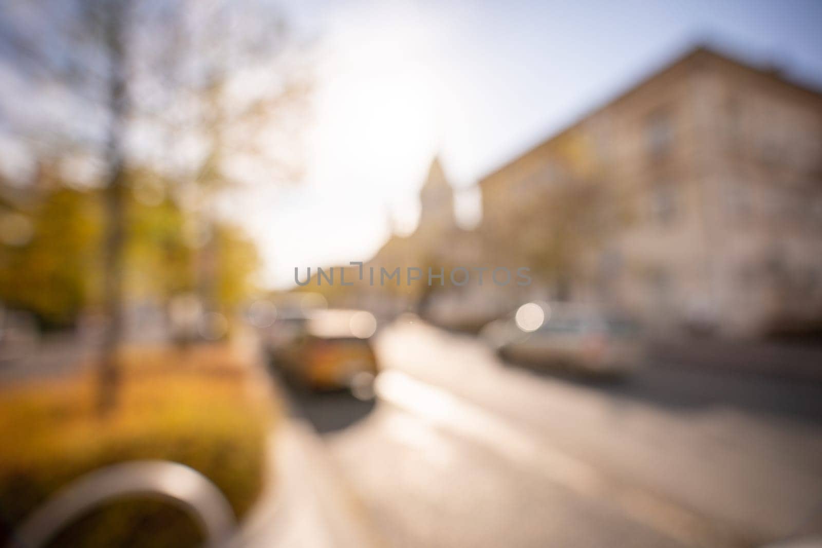 Autumn season bokeh background. Abstract city blur along the road with cars. by Matiunina