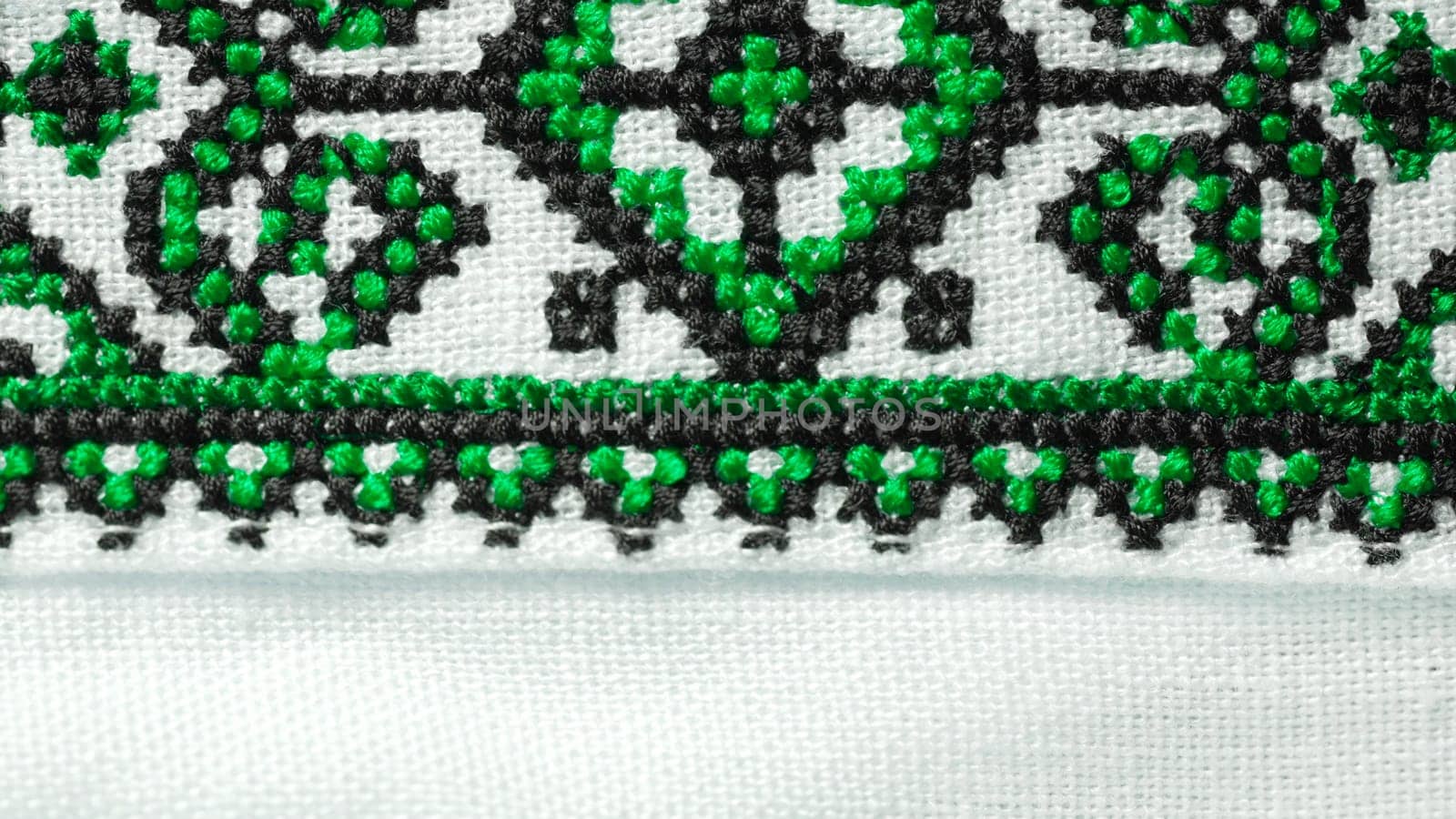 Handmade embroidery on Ukrainian shirt. Geometric ornaments, ancient traditional authentic clothes of Ukrainians. Colorful screen saver, vyshyvanka. Ethnic craft. High quality photo