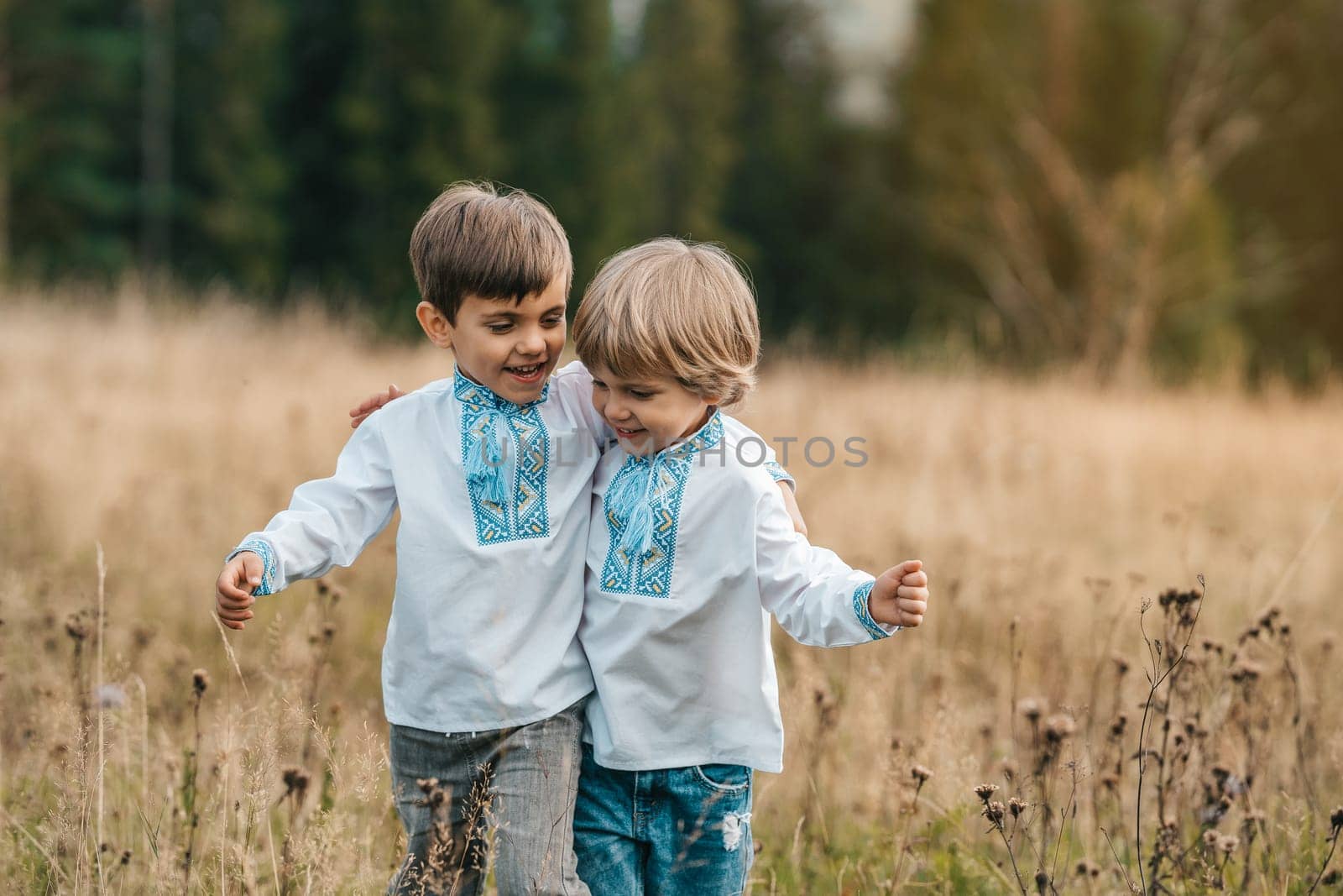 Happy glad boys - Ukrainian patriots children on meadow of Carpathian mountain. by kristina_kokhanova