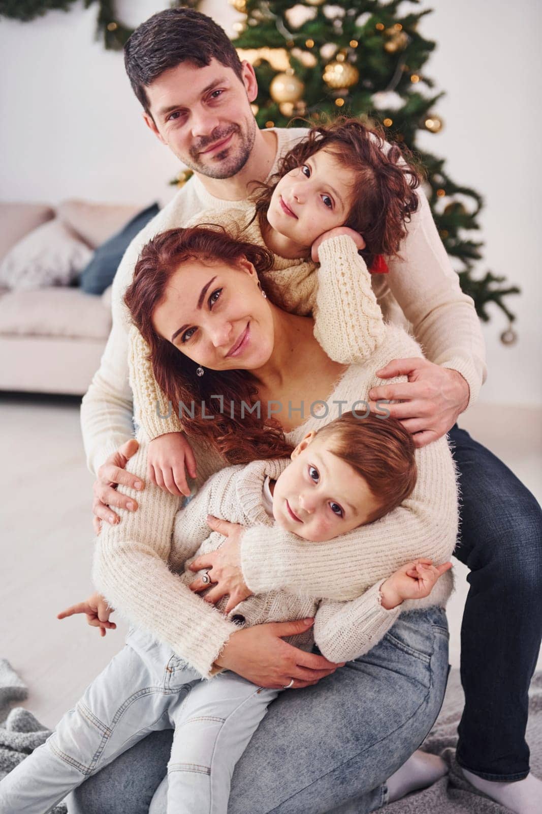 Posing for the camera. Family celebrating new year with their children at home.