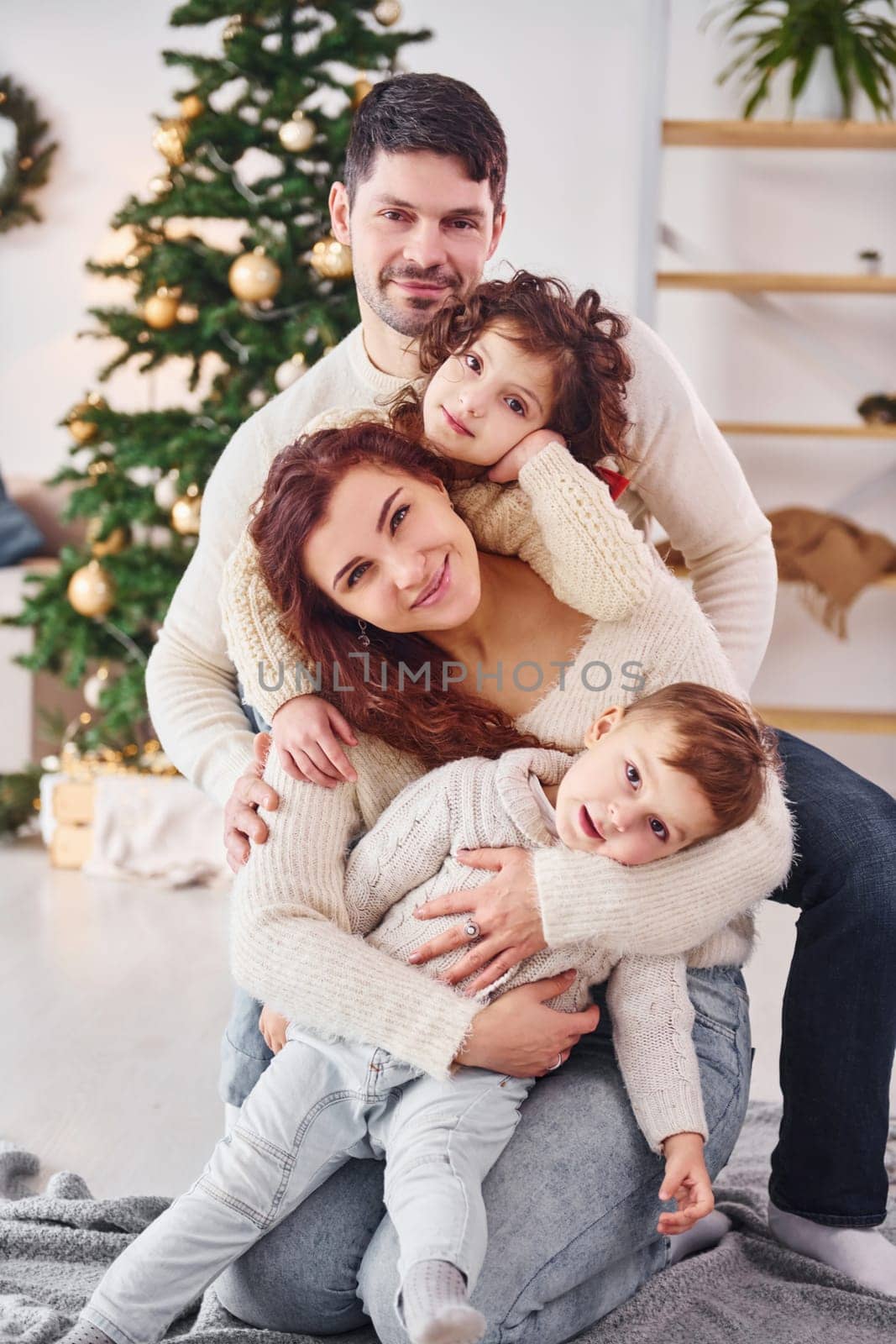 Posing for the camera. Family celebrating new year with their children at home.