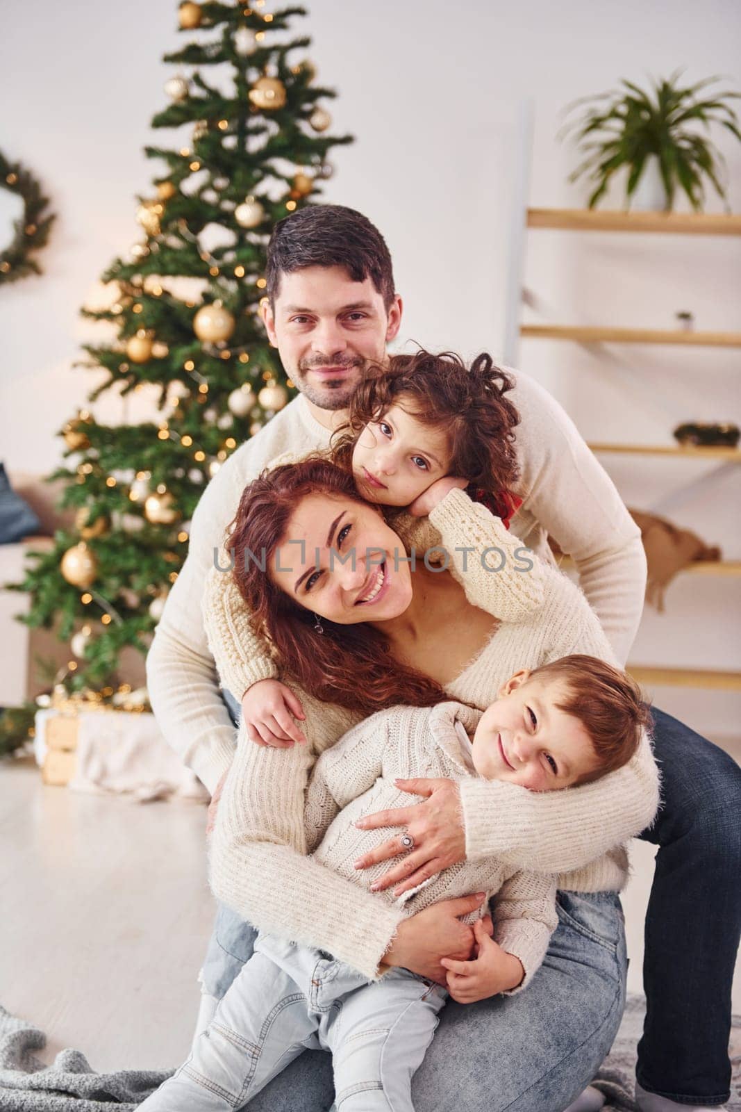 Posing for the camera. Family celebrating new year with their children at home.