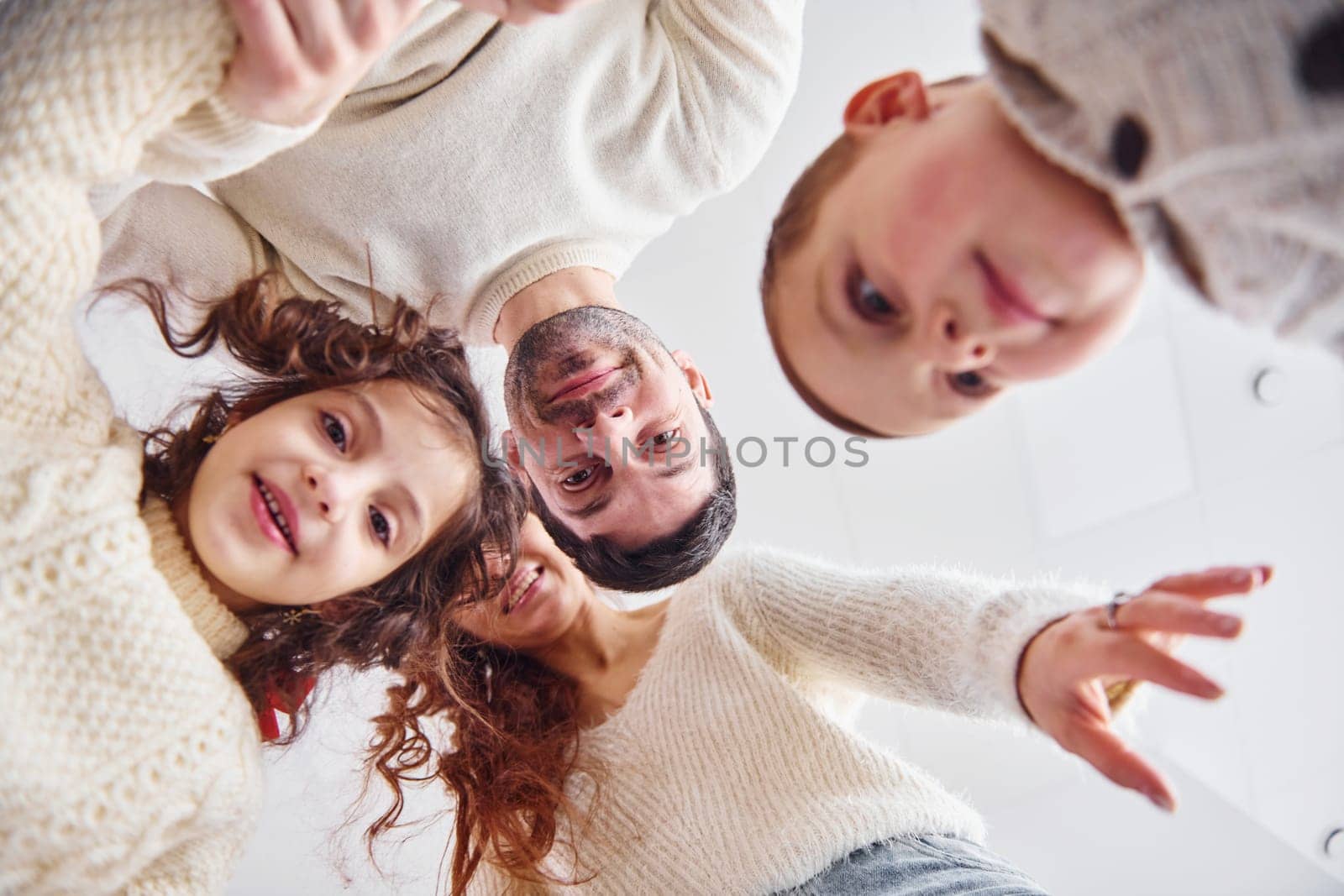 View from below. Happy family looking down and having fun.