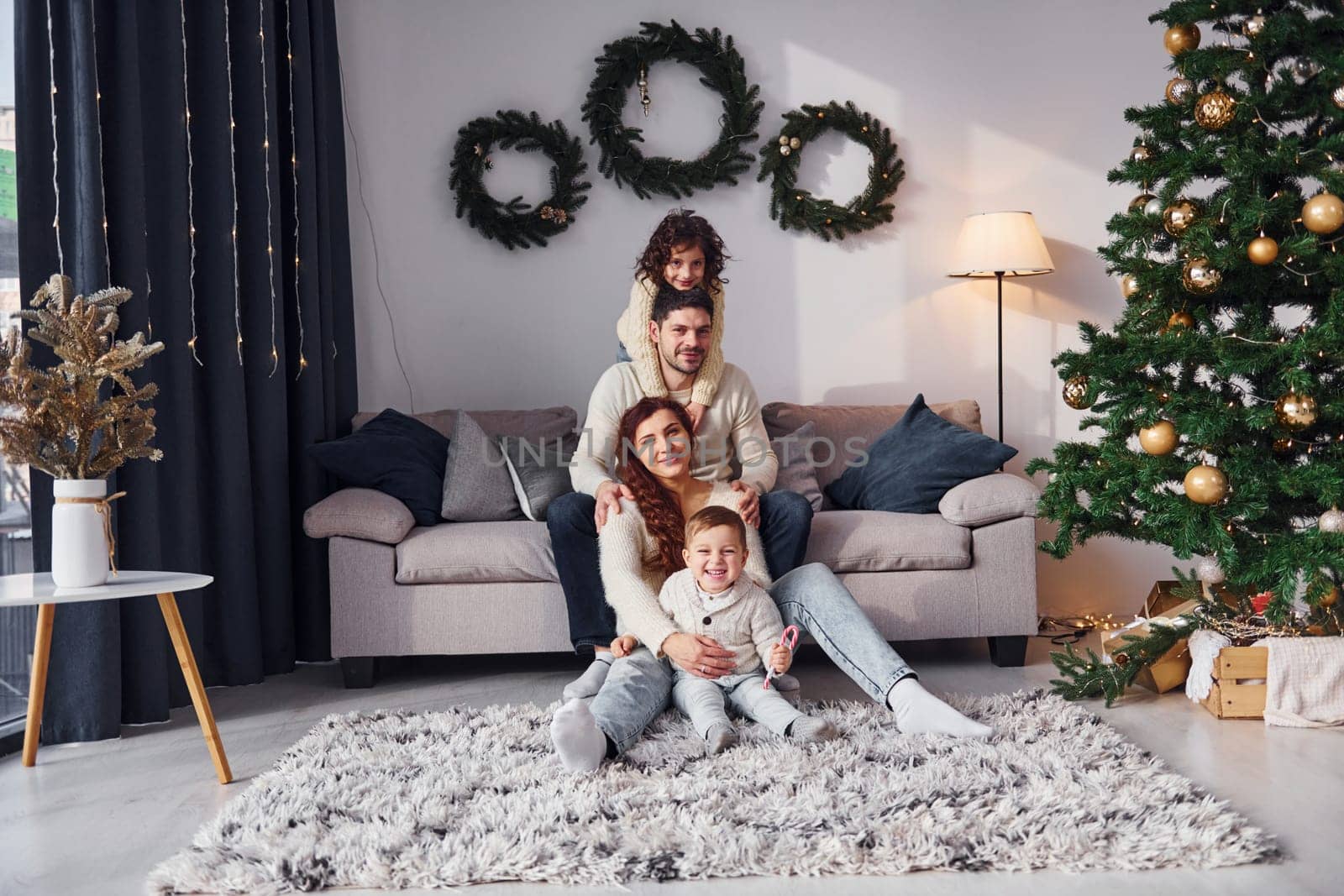 Conception of holidays. Family celebrating new year with their children at home.