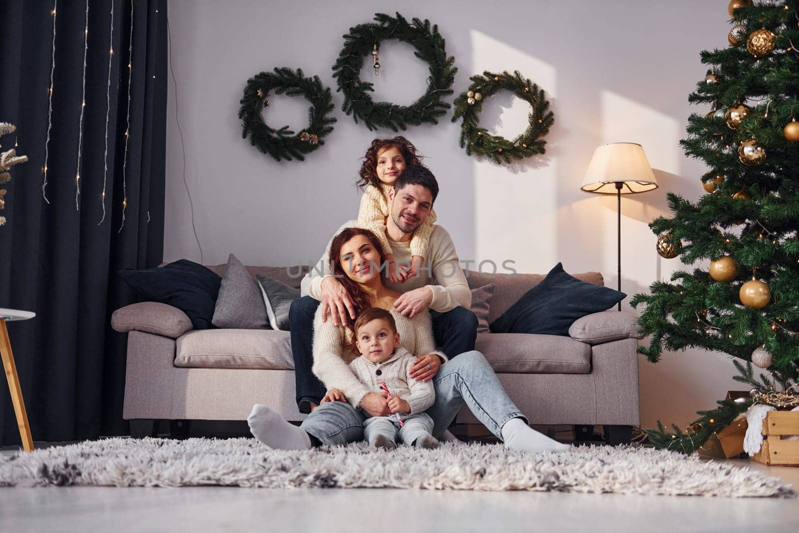Conception of holidays. Family celebrating new year with their children at home.