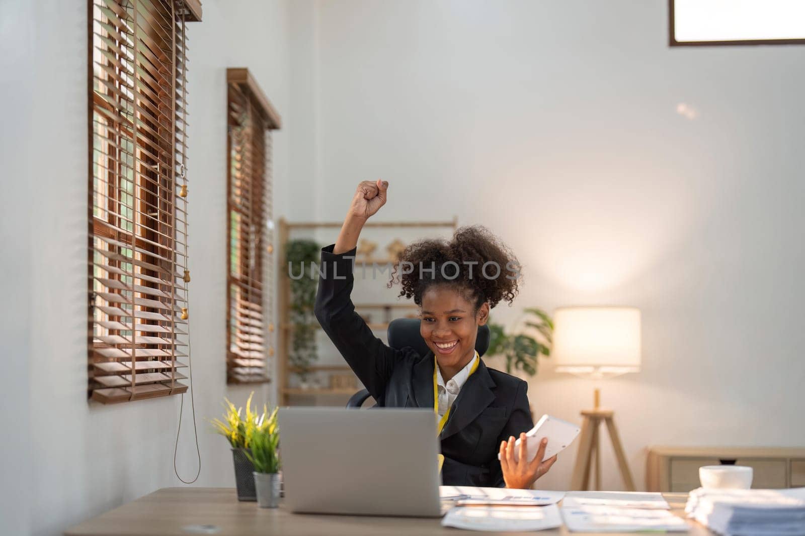 Financial advisor, corporate accountant and African American woman in office. celebrating success achievement. positive expression, success in business concept.