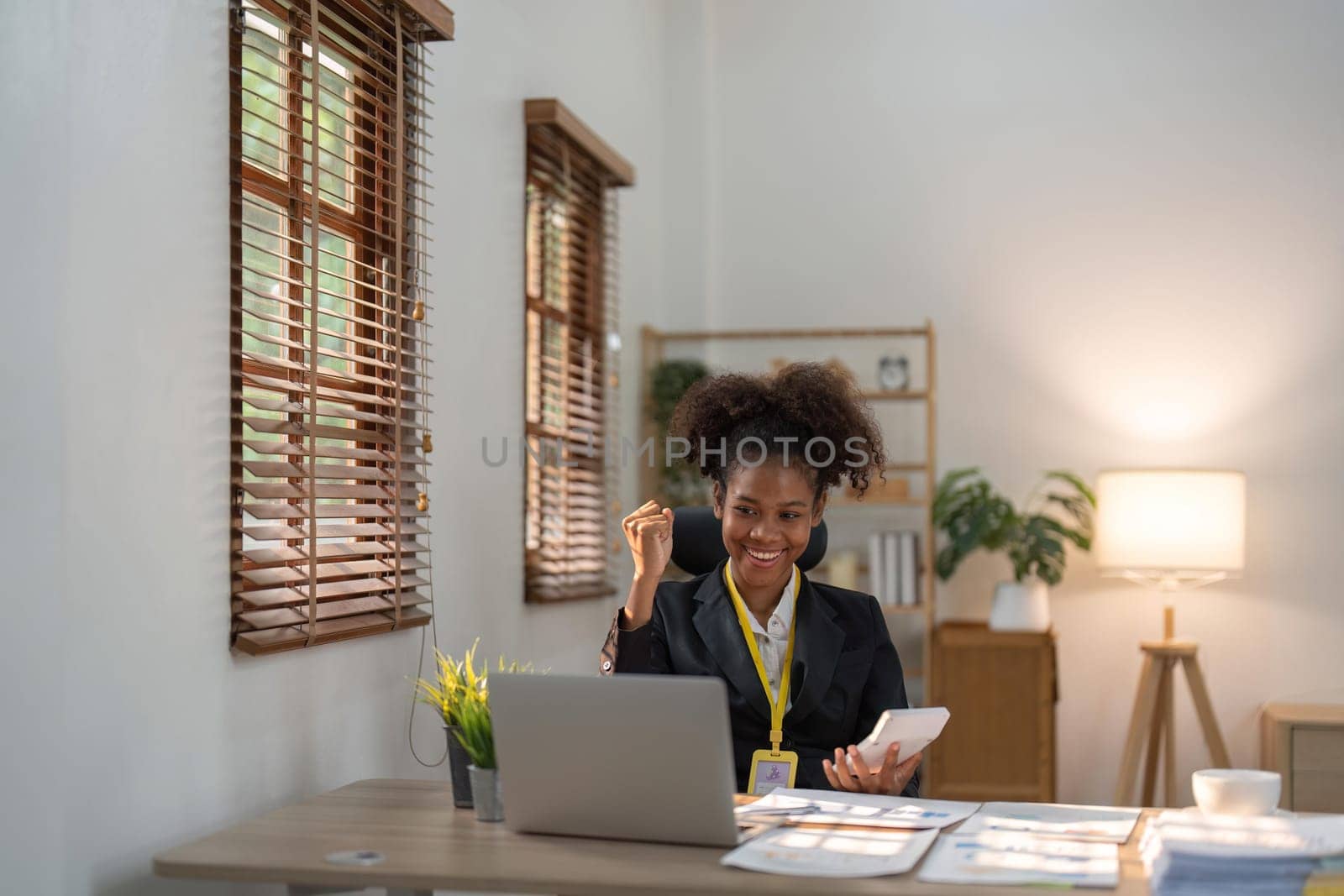 Financial advisor, corporate accountant and African American woman in office. celebrating success achievement. positive expression, success in business concept.