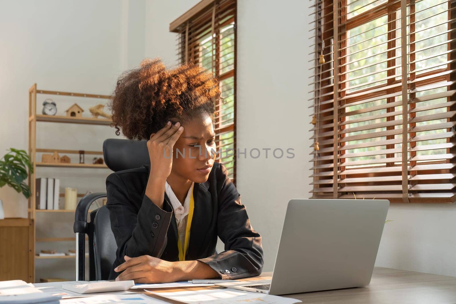 Stress, anxiety and burnout with a business black woman at work using a laptop while suffering from a headache. Compliance, computer and mental health with a female employee struggling on a deadline.