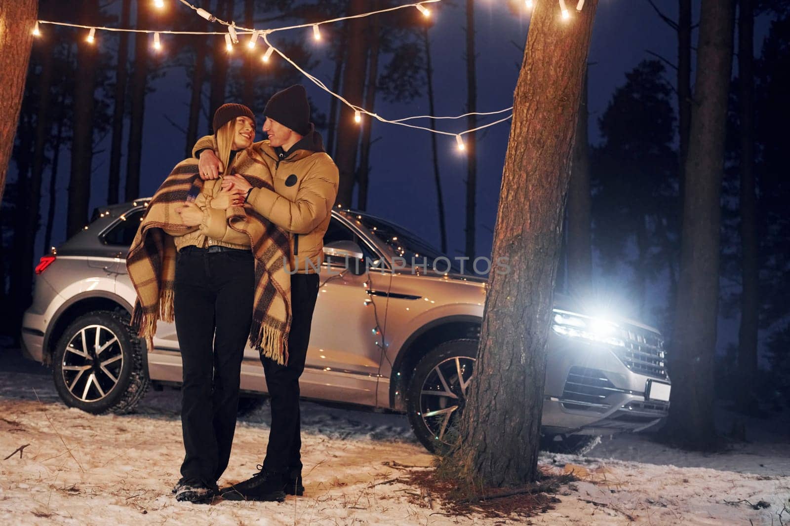 Conception of love. Couple standing in the forest and celebrating New year.