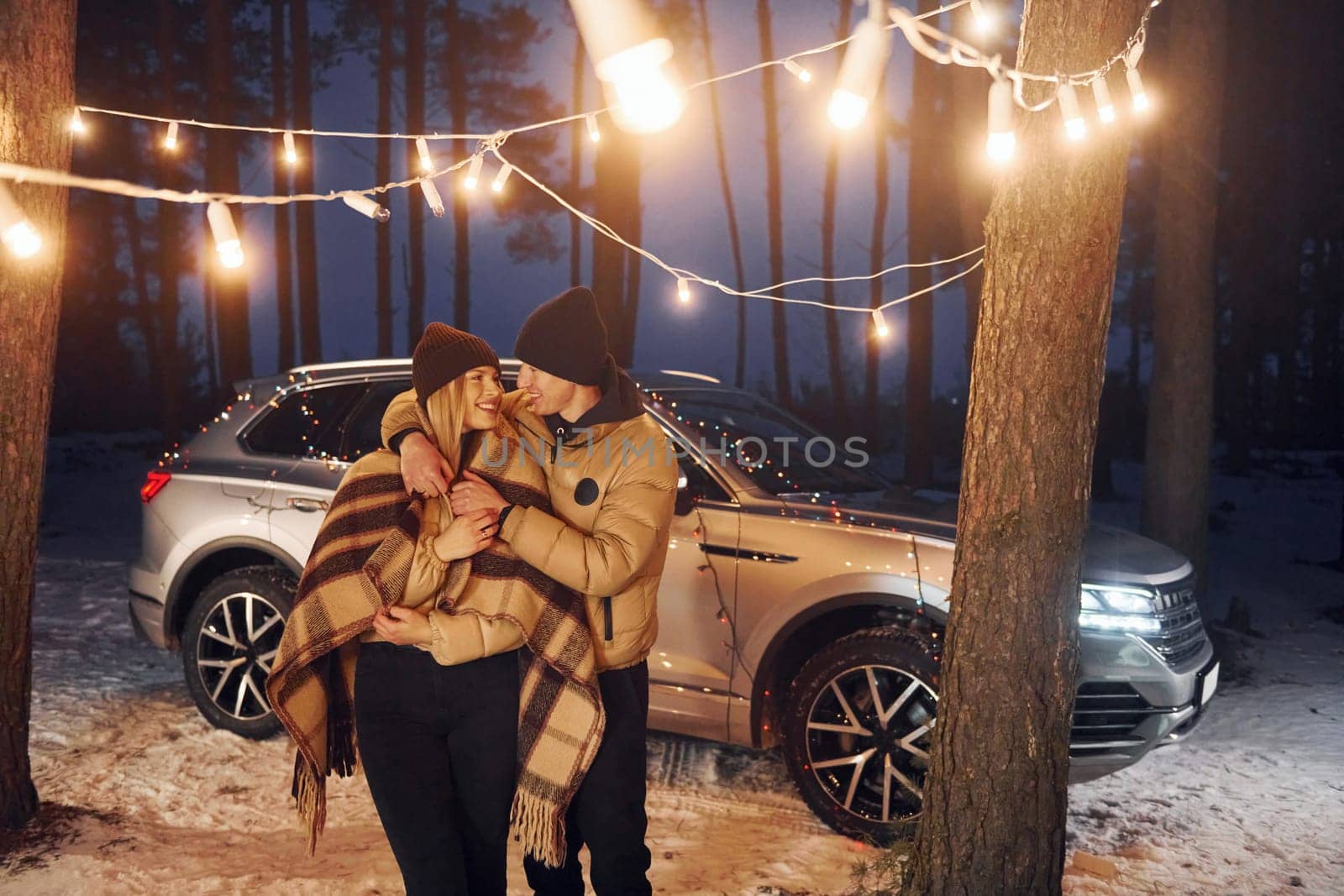 Conception of love. Couple standing in the forest and celebrating New year.