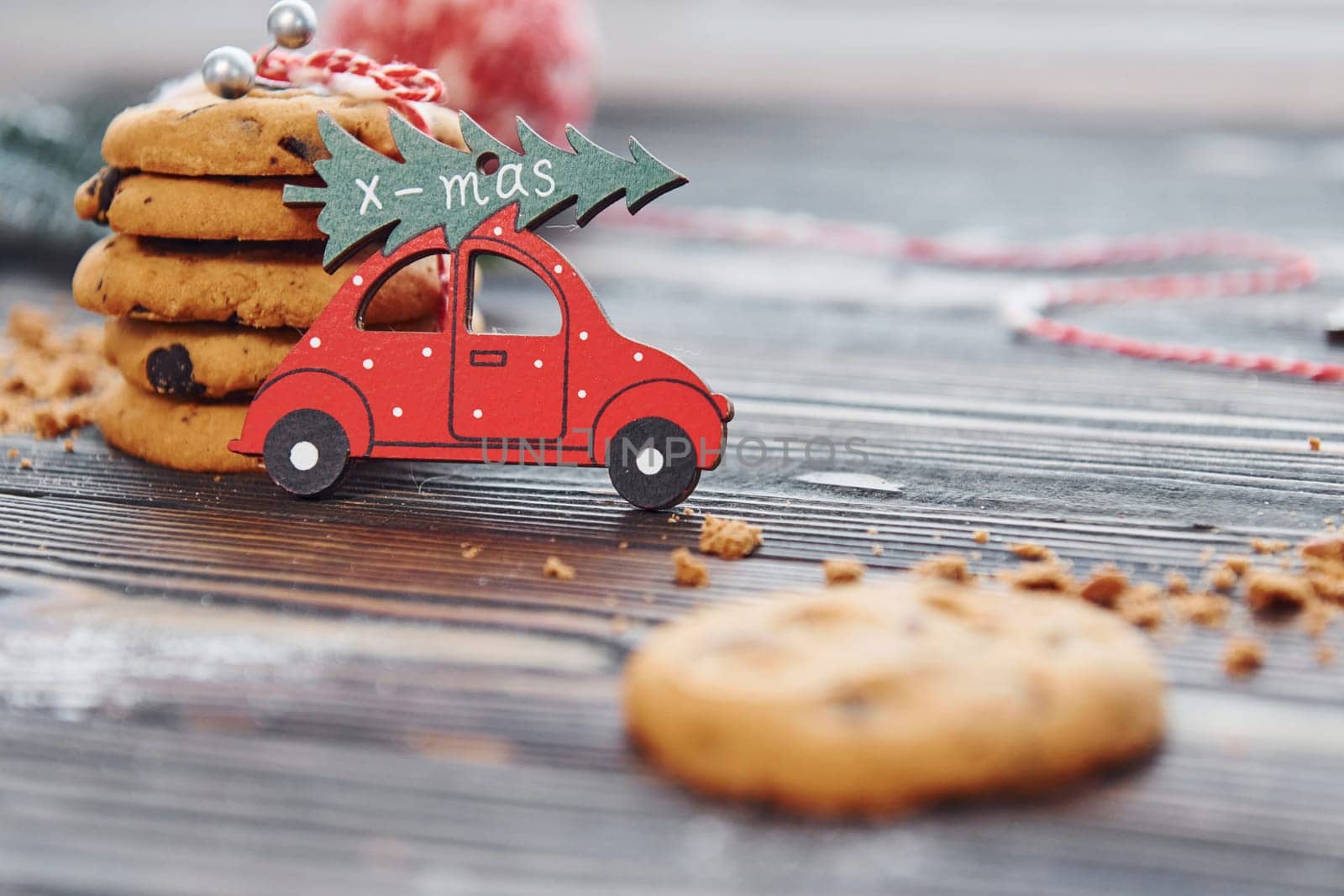 Red toy car. Christmas background with holiday decoration.