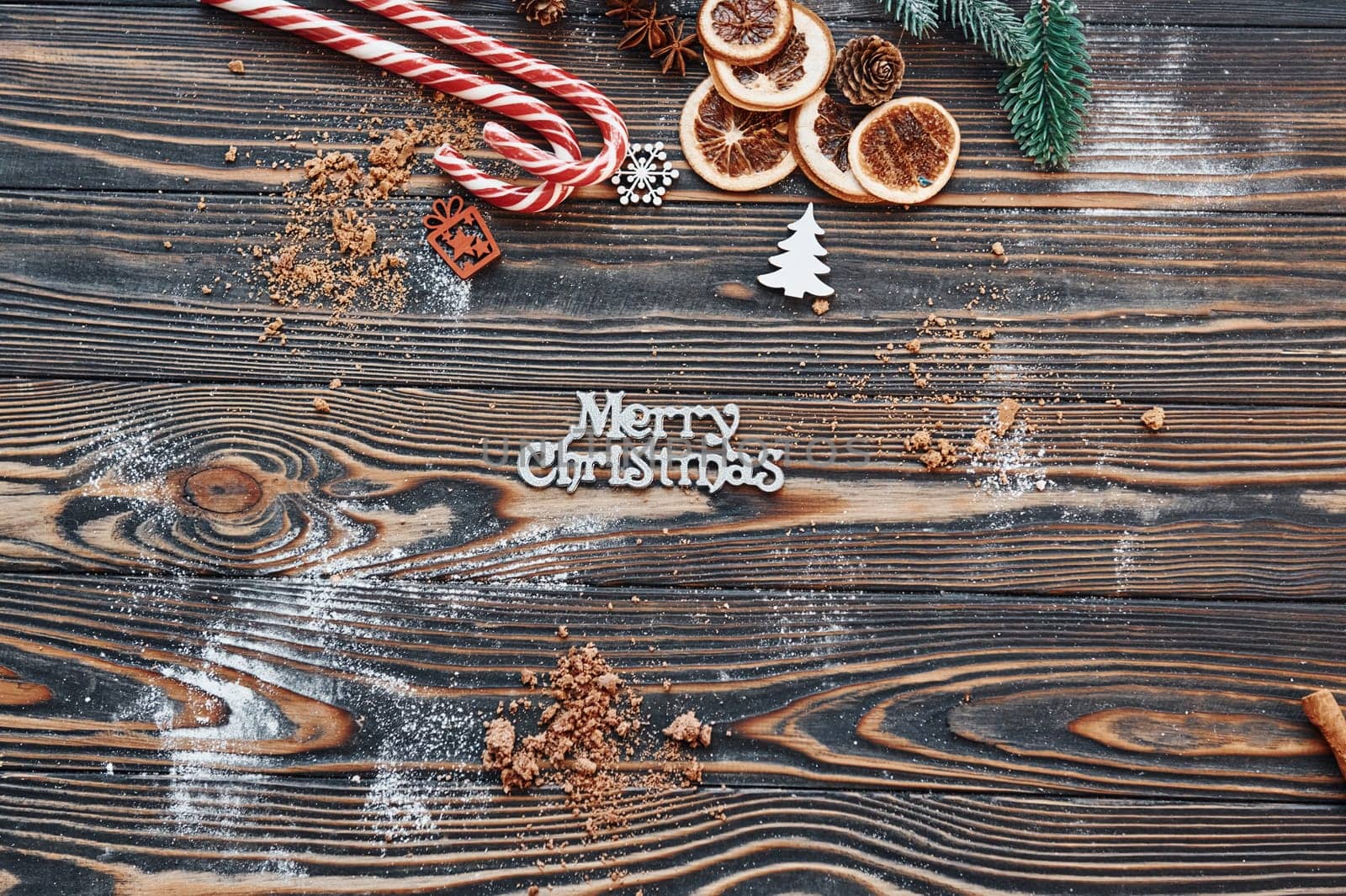Candies and slices of oranges. Christmas background with holiday decoration.
