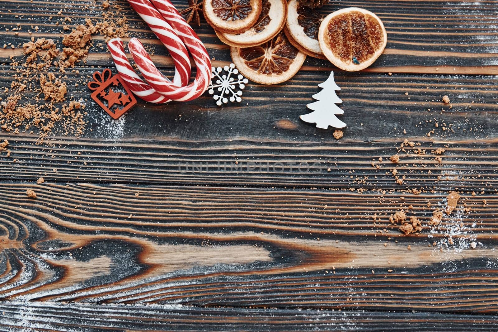 Candies and slices of oranges. Christmas background with holiday decoration.