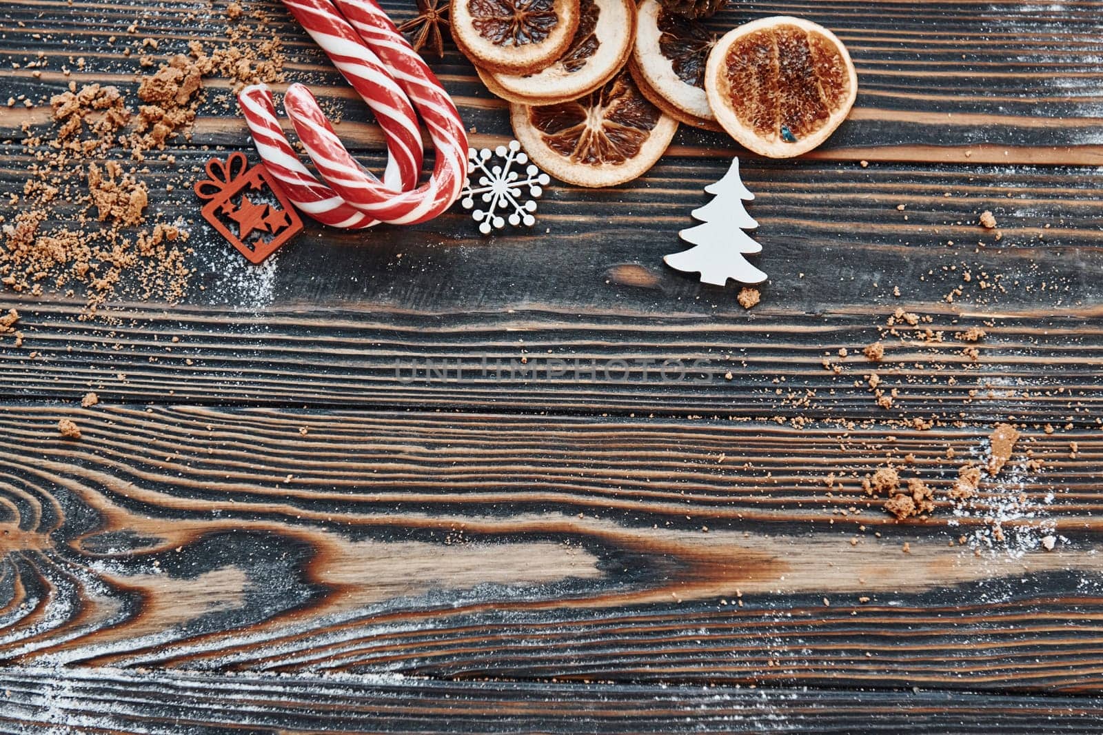 Candies and slices of oranges. Christmas background with holiday decoration.