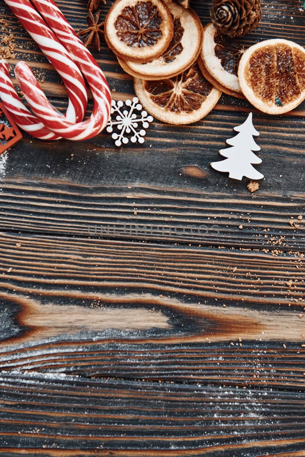 Candies and slices of oranges. Christmas background with holiday decoration by Standret