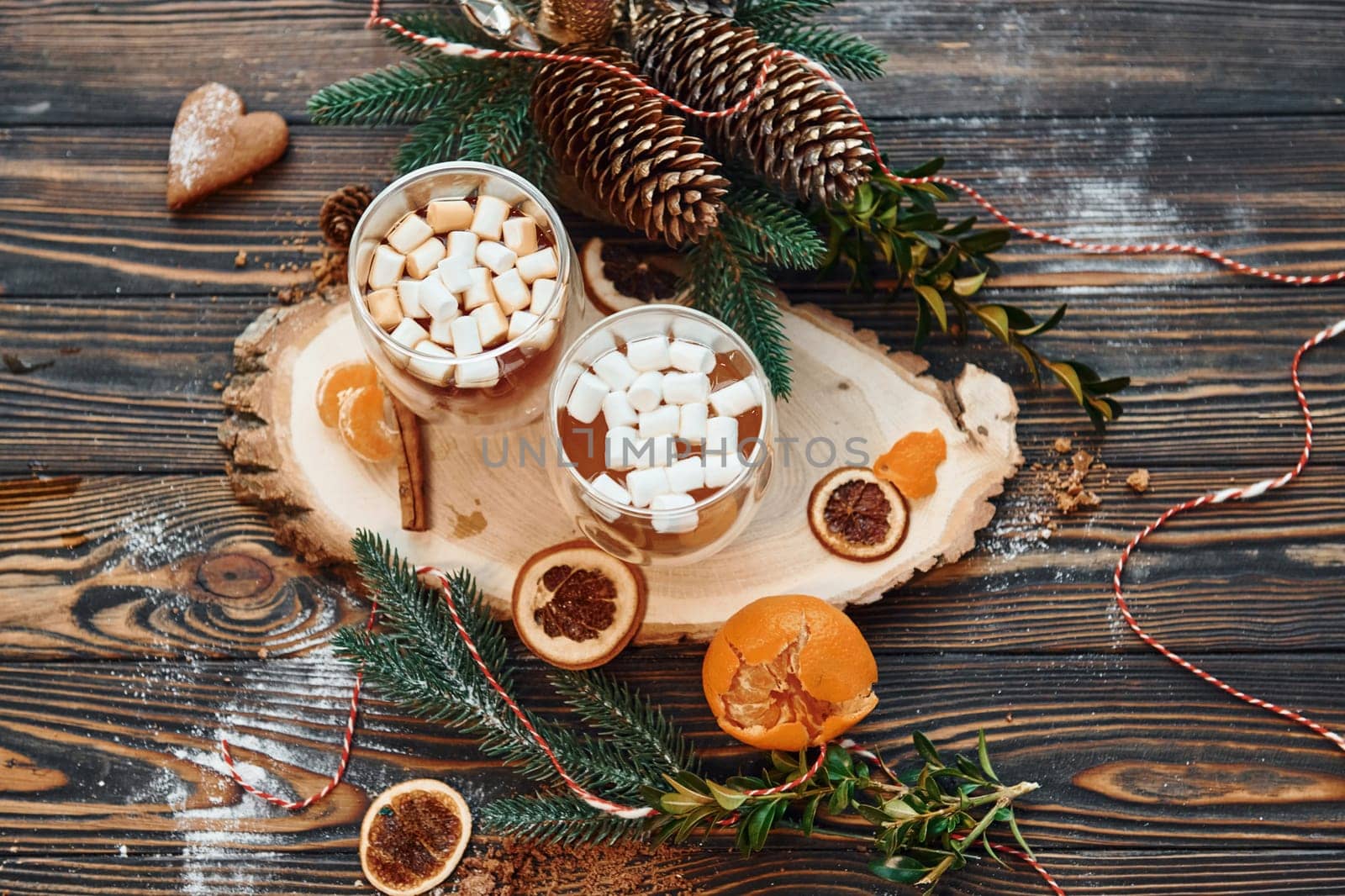 Glasses with hot drink. Christmas background with holiday decoration.