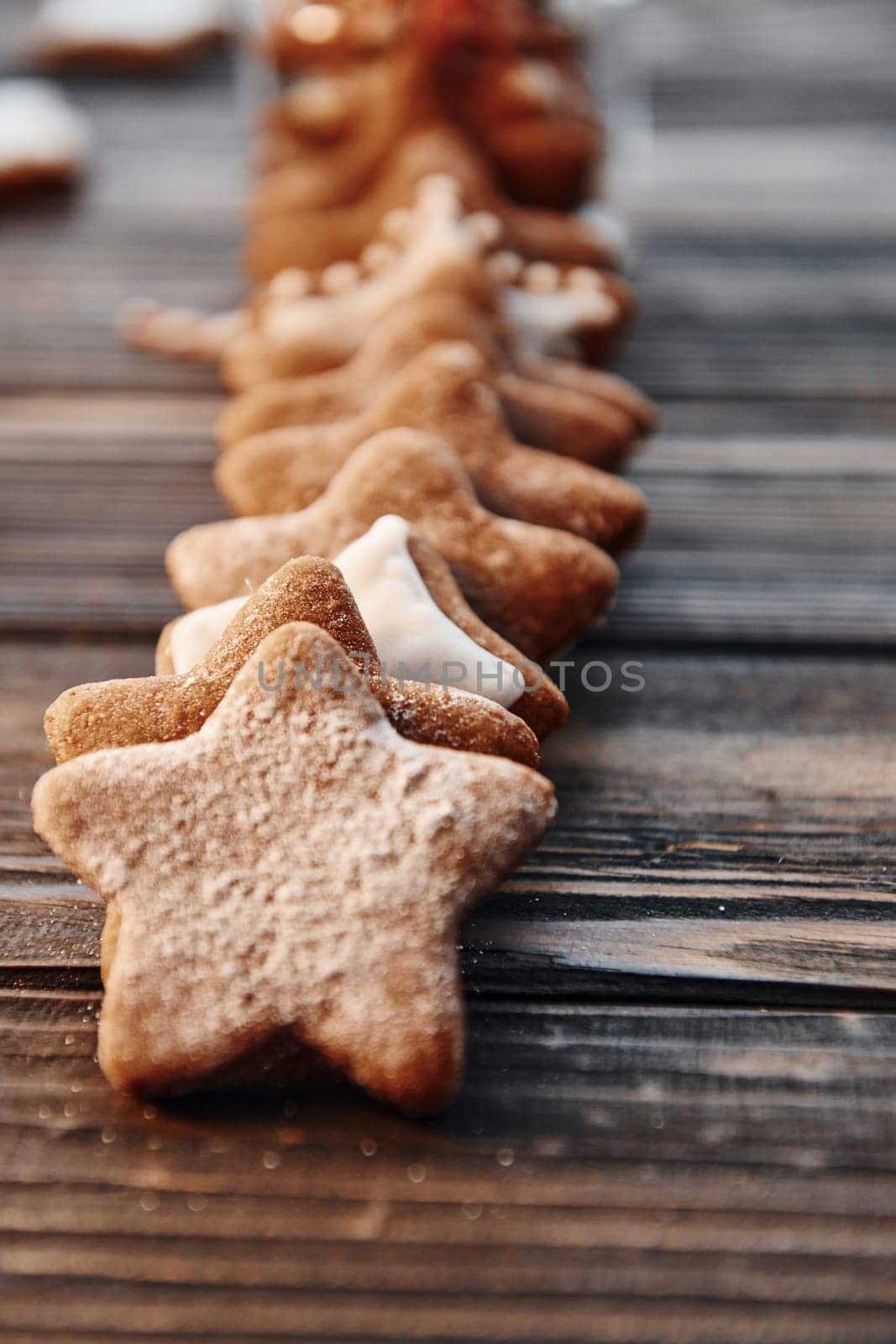 Cookies laying down in a row. Christmas background with holiday decoration.