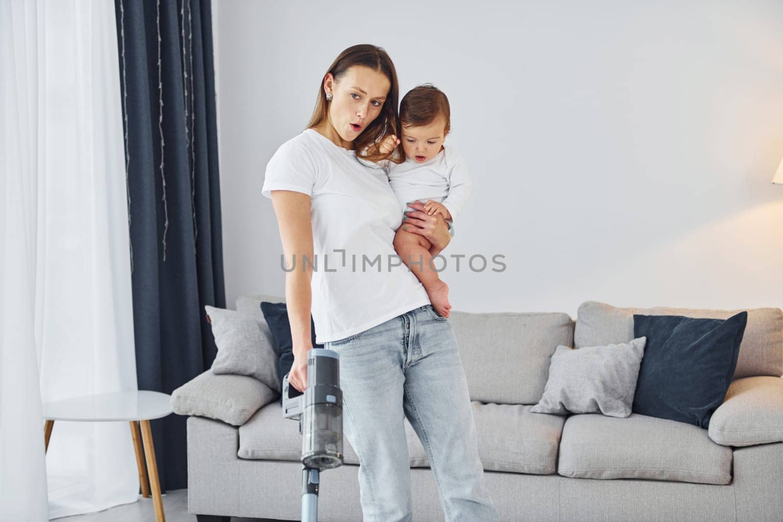 Domestic life. Mother with her little daughter is indoors at home together.