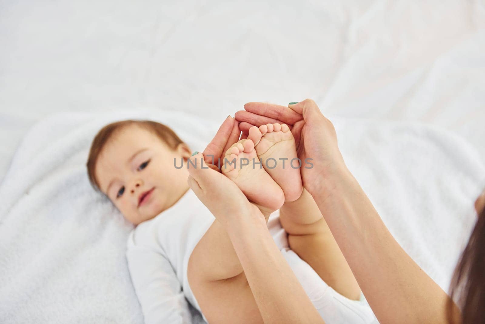 Playing around. Mother with her little daughter is indoors at home together.