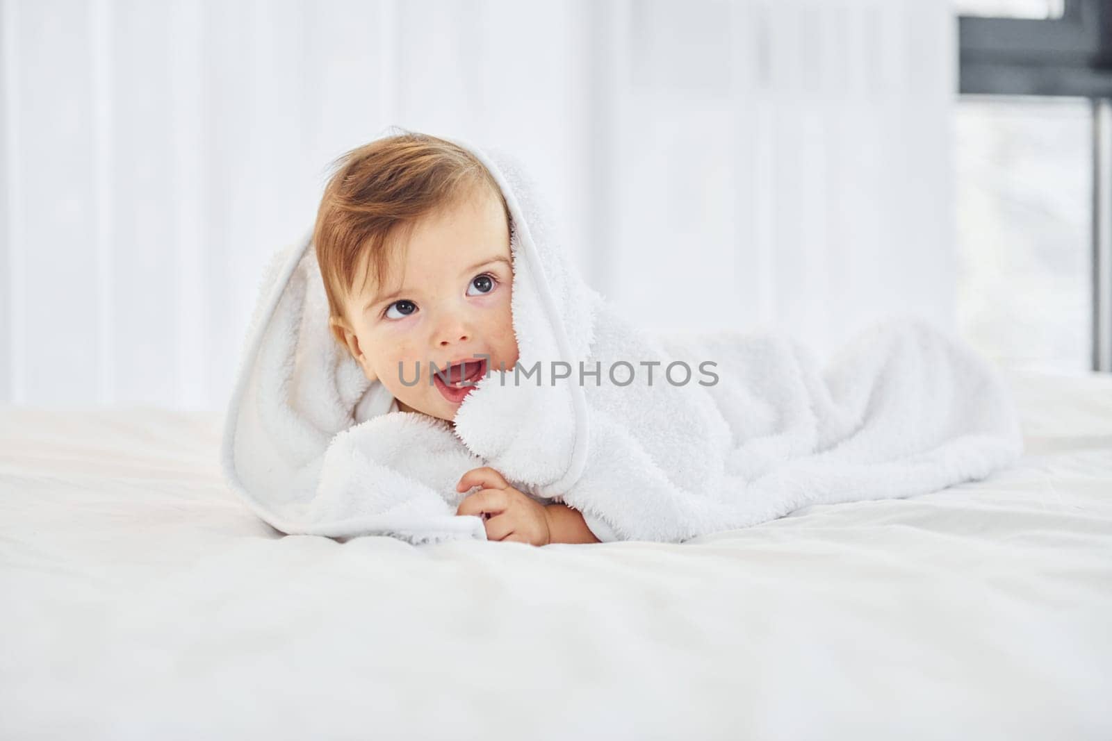 Positive emotions. Cute little baby is indoors in the domestic room.