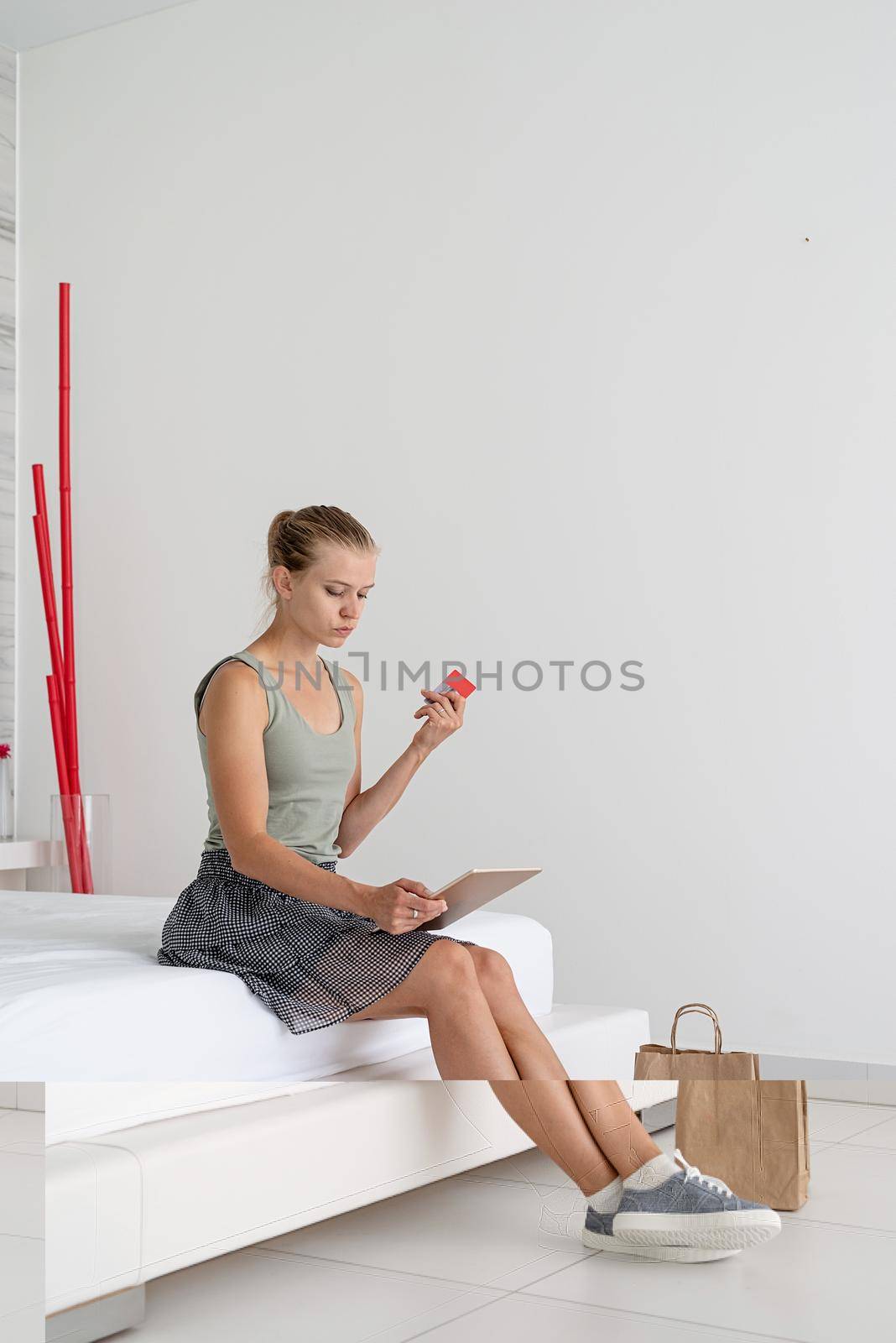 Online shopping. Young woman shopping online from home using tablet