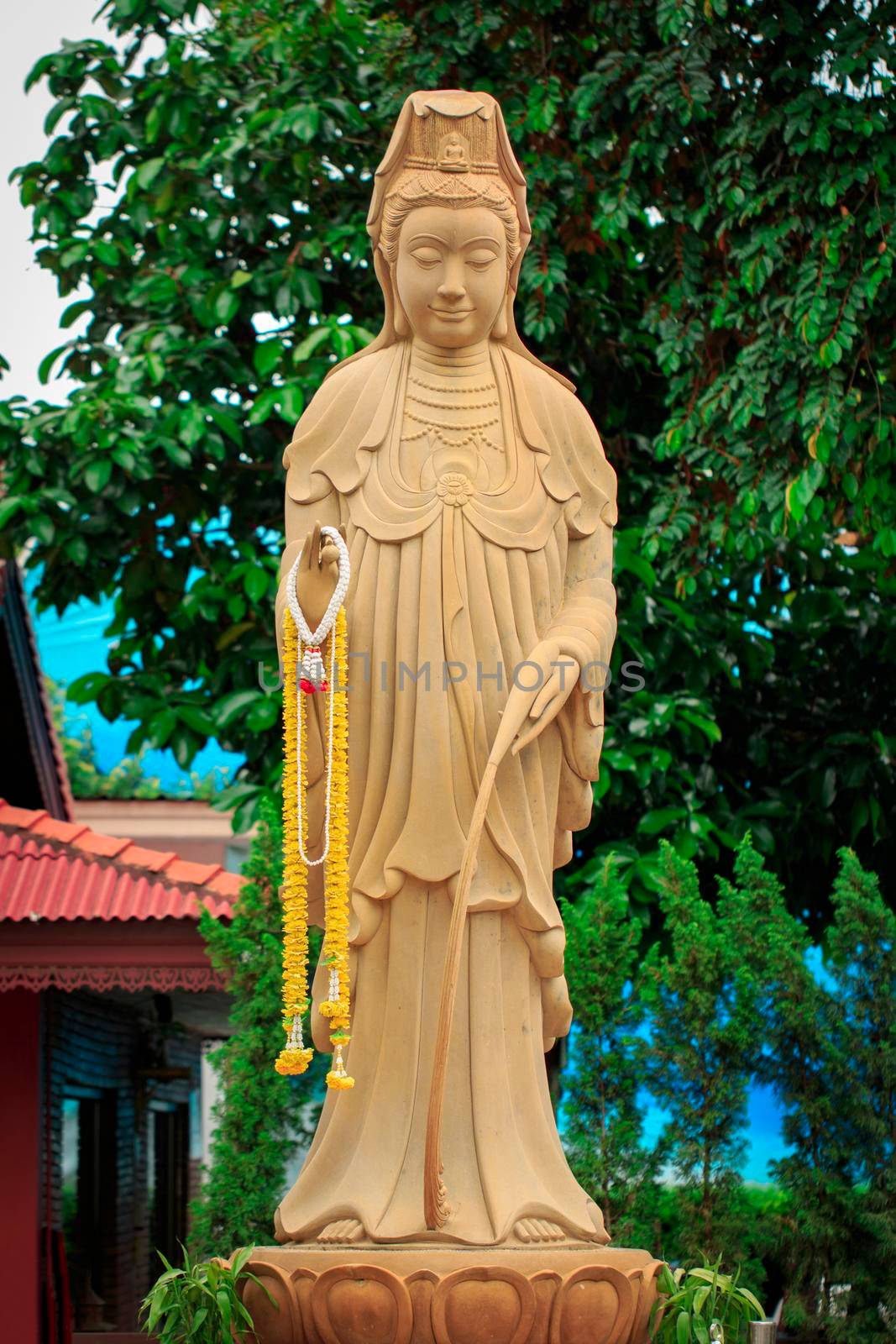 The statue of the Guanyin Boddhisatva on nature background. Religion