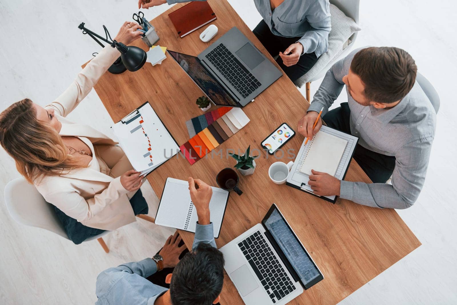Top view. Group of business people that working on the project in the office.
