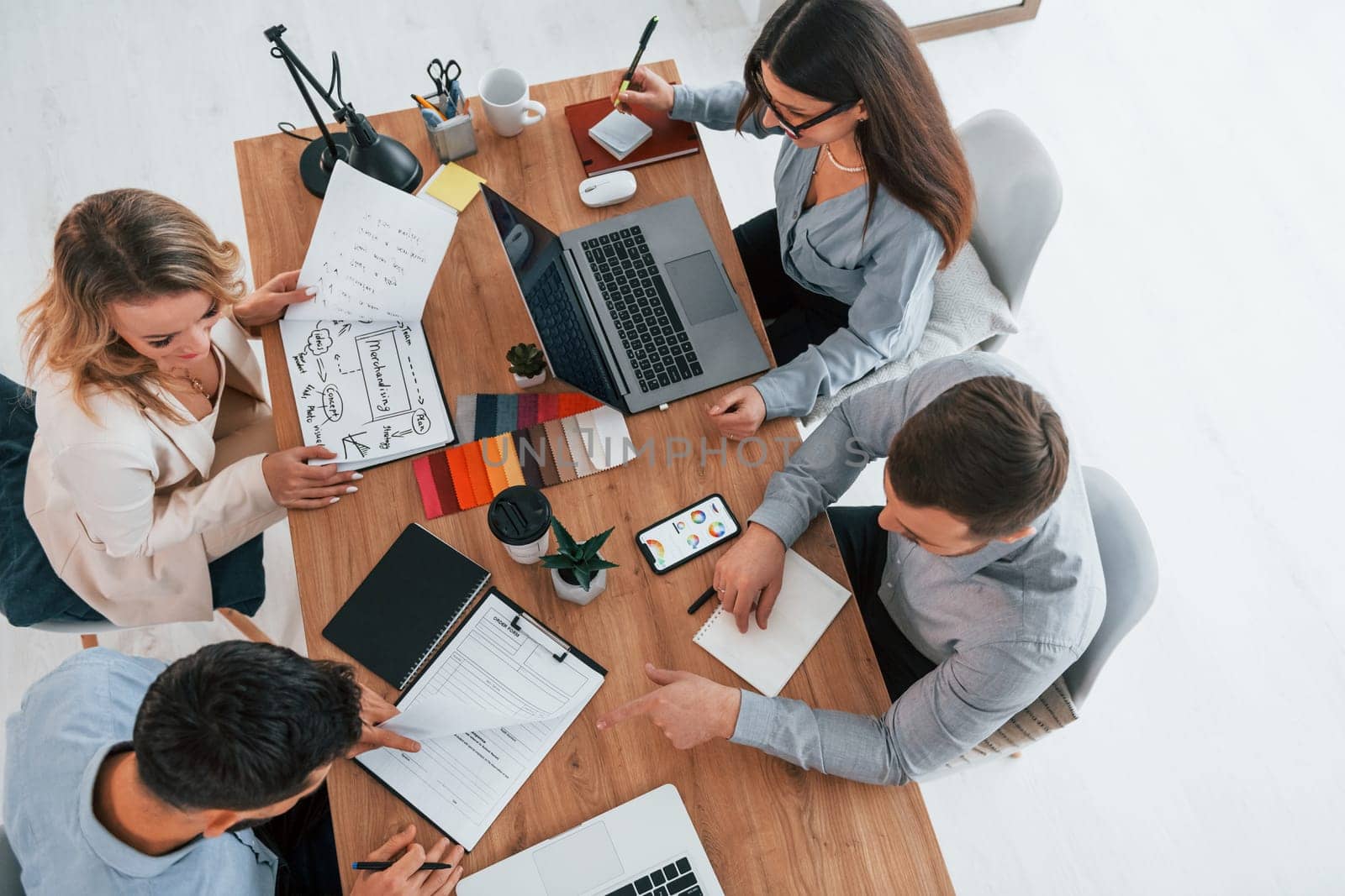 Top view. Group of business people that working on the project in the office.