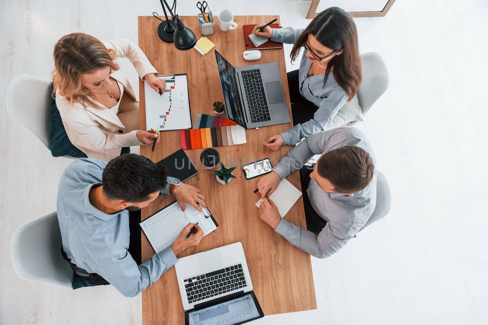 Top view. Group of business people that working on the project in the office.