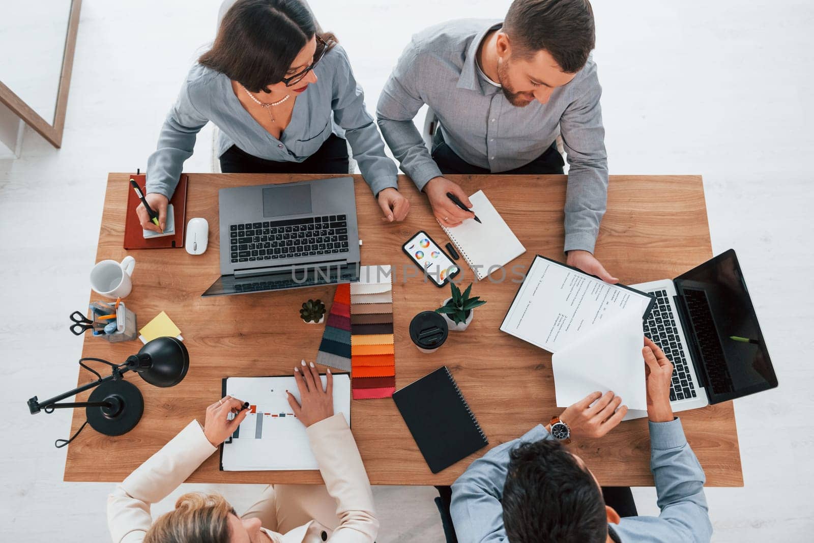 Having conversation. Group of business people that working on the project in the office.