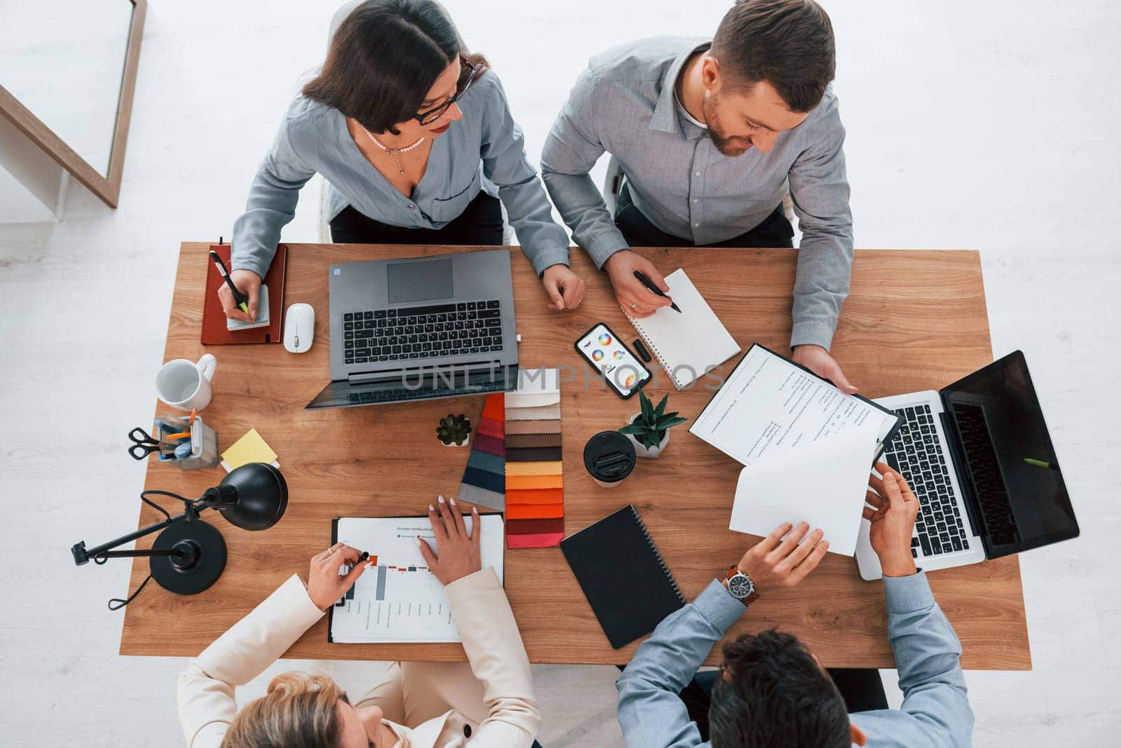 Having conversation. Group of business people that working on the project in the office.