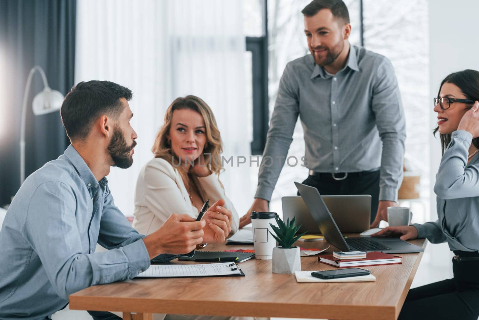 Having conversation. Group of business people that working on the project in the office.