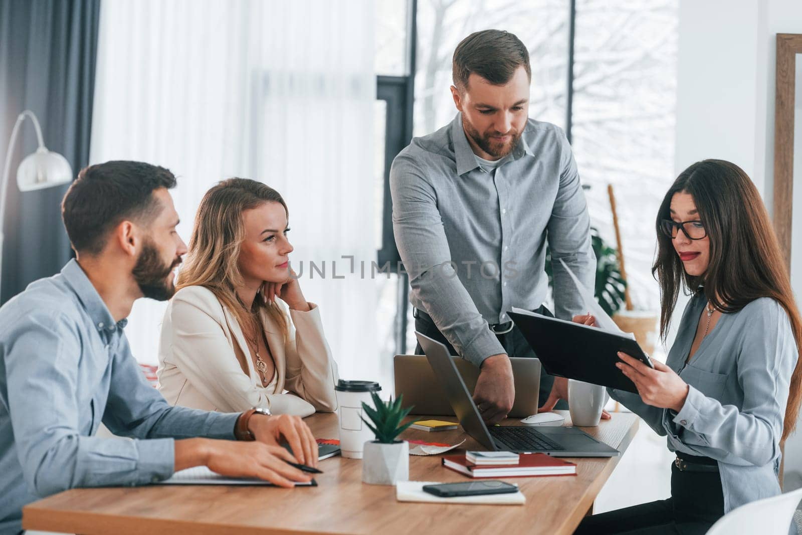 Modern office. Group of business people that working on the project.