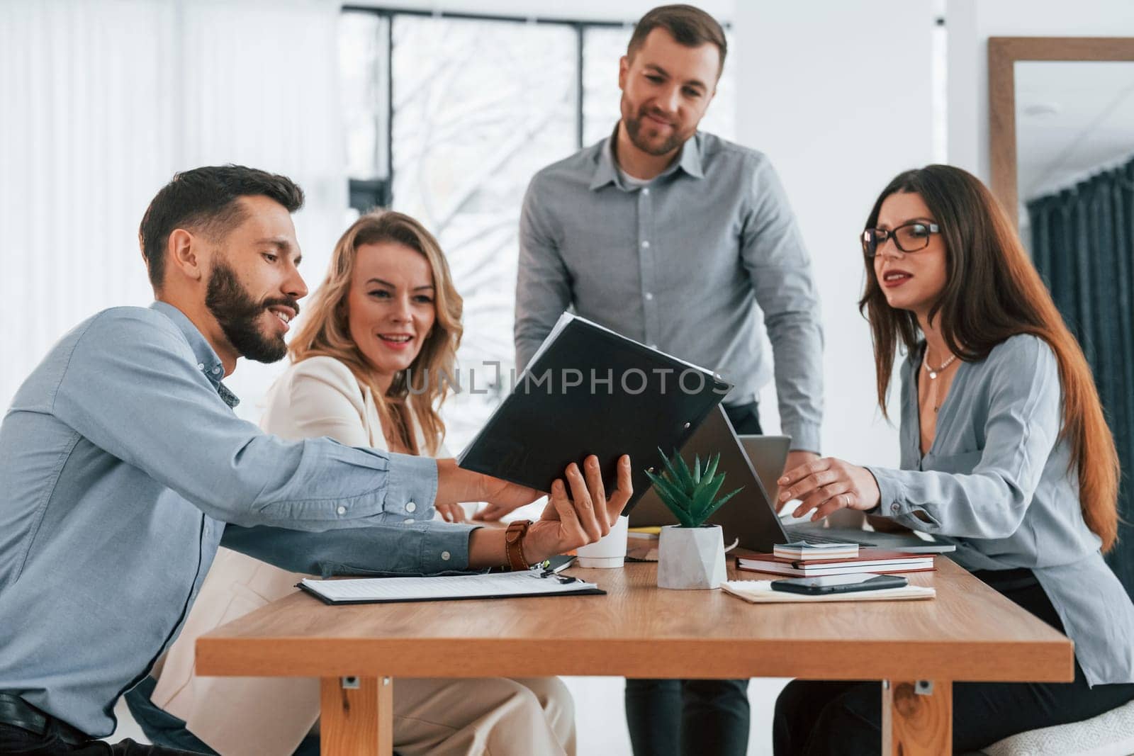 Conception of success. Group of business people that working on the project in the office.