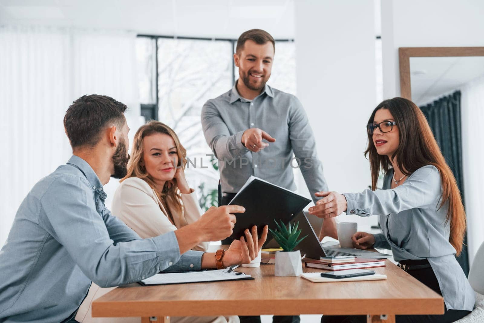 Positive employees. Group of business people that working on the project in the office.