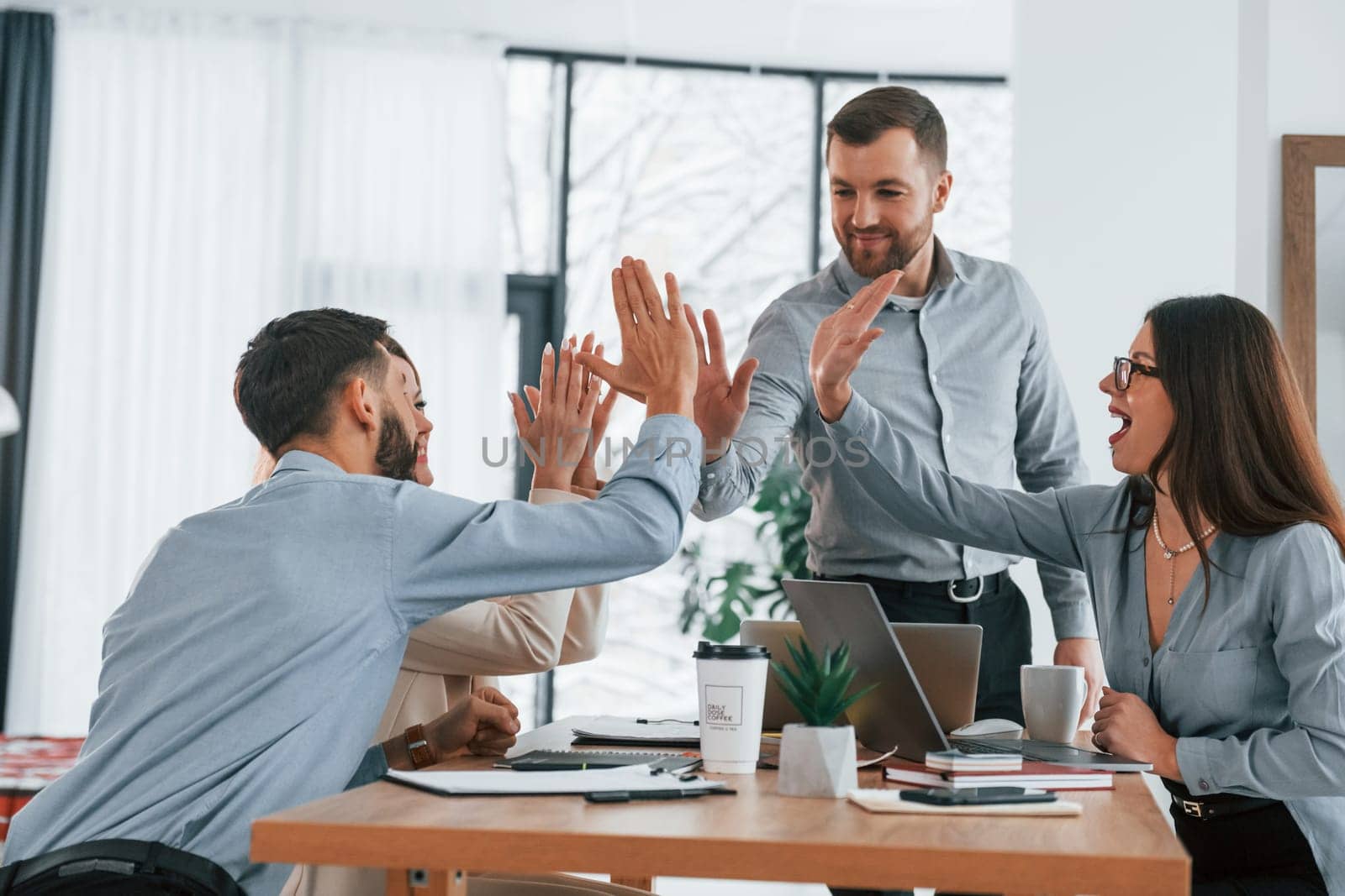 Using brainstorming technique. Group of business people that working on the project in the office.