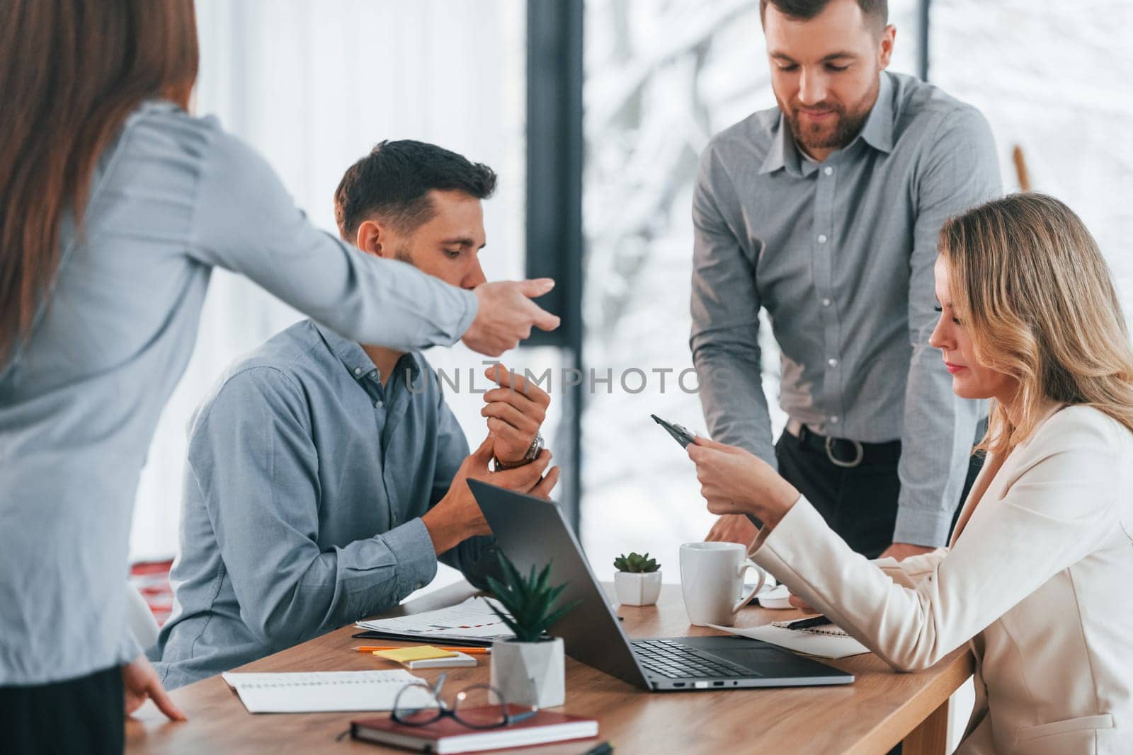 Using brainstorming technique. Group of business people that working on the project in the office.